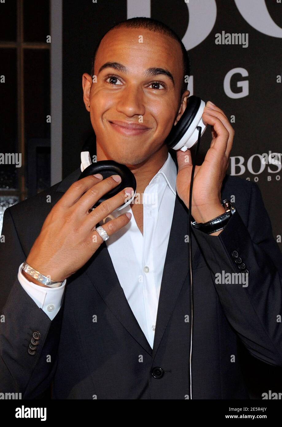 McLaren Formula One driver Lewis Hamilton of Britain smiles as he plays  music as a special guest during a cocktail event at the Hugo Boss Menswear  Store in Milan September 8, 2010.