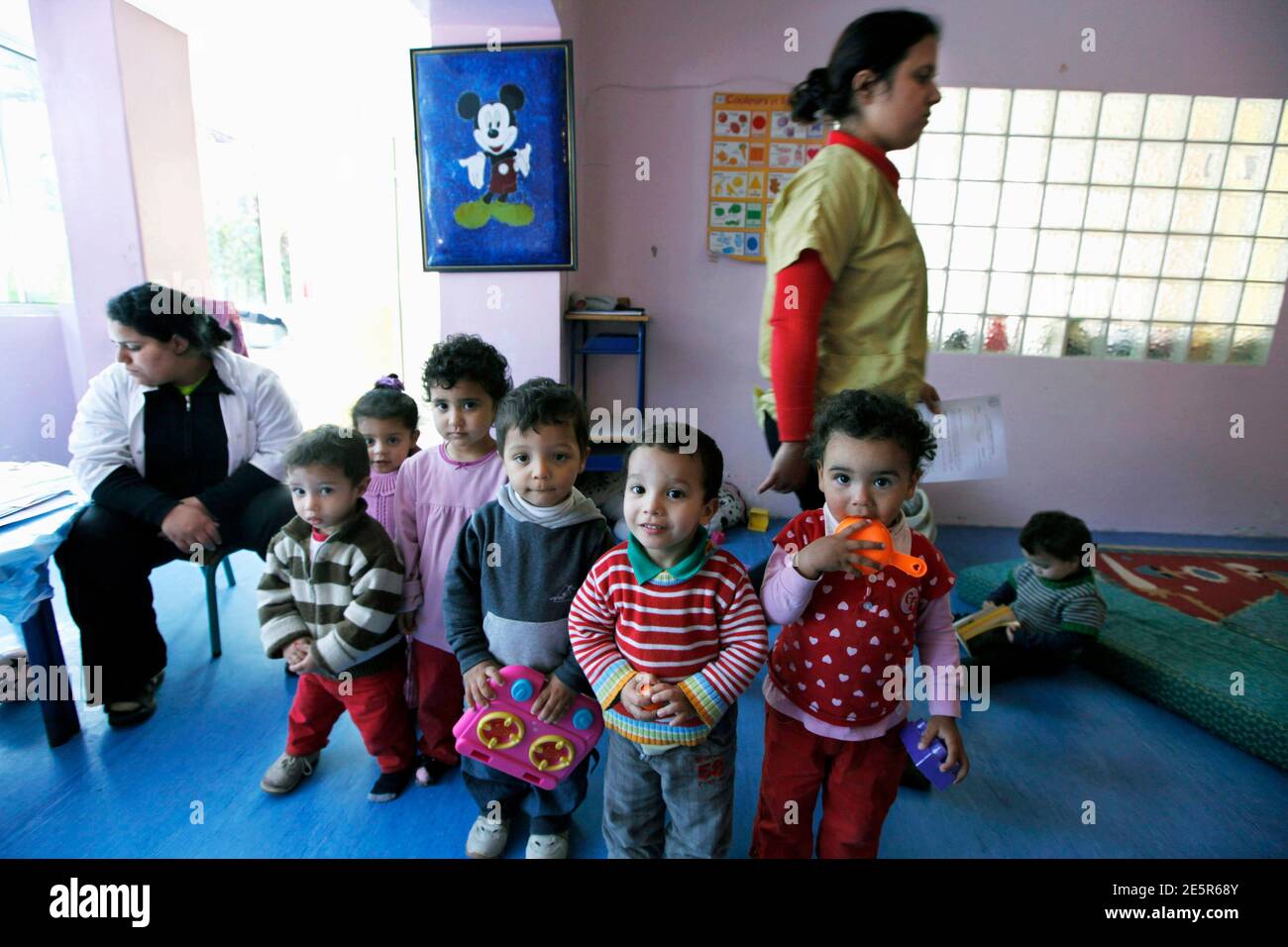Children play at the kindergarten at the non-profit organization Woman's Solidarity, which helps unmarried mothers rebuild their lives and overcome social stigma, in Casablanca March 3, 2011. At the westernmost boundary of the Muslim world, and only a stone throw's away from Europe, Moroccan women find themselves enjoying more freedoms. But unwed mothers remain outcast. Since 1985, Women's Solidarity has offered help to thousands of unmarried mothers for whom the only to avoid shame and public disapproval is often giving up their babies, teaching them skills that can bring them an income such  Stock Photo