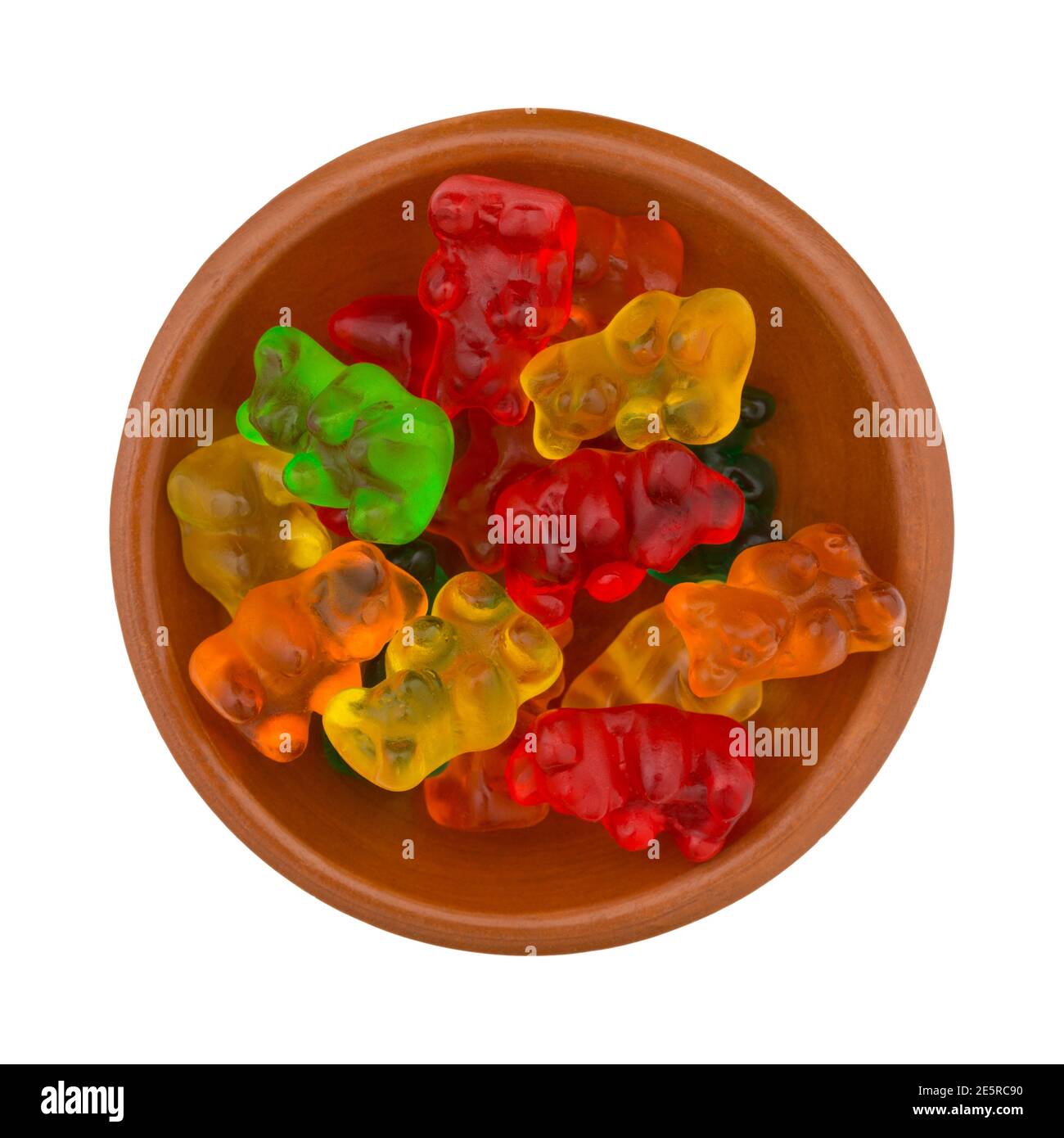 Overhead view of a bowl of colorful gummi bear sugar candies isolated on a white background. Stock Photo