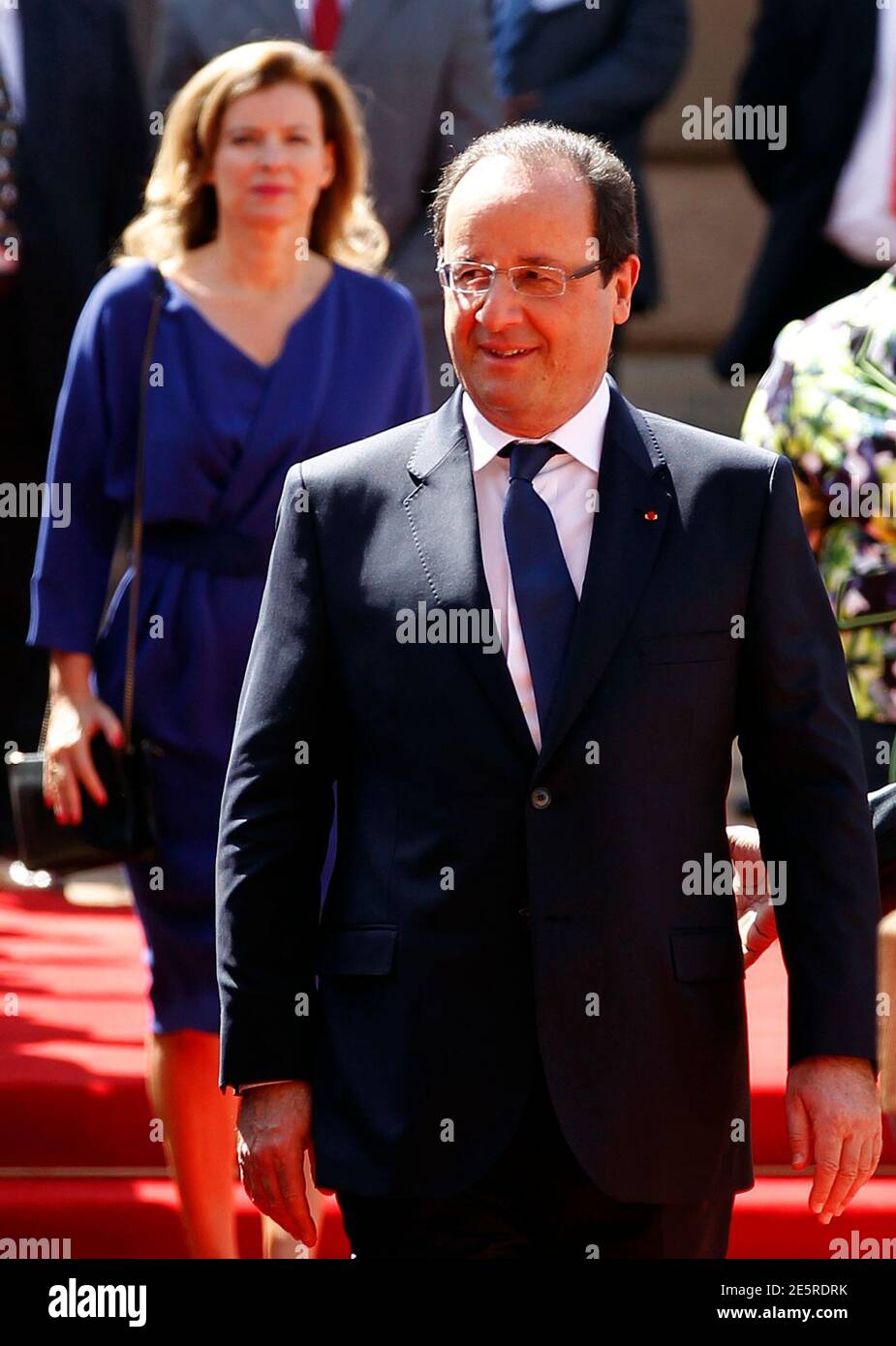 French President Francois Hollande looks on as he is followed by his wife Valerie Trierweiler at the Union building in Pretoria October 14, 2013. France will lend 100 million euros ($135 million) to South African state power utility Eskom to help it finance solar power projects in Africa's largest economy, according to a communique obtained by Reuters on Monday. The deal will be signed as a part of a summit between Hollande and South Africa's President Jacob Zuma, which started on Monday in Pretoria. Reuters/Siphiwe Sibeko (SOUTH AFRICA - Tags: POLITICS BUSINESS ENERGY) Stock Photo