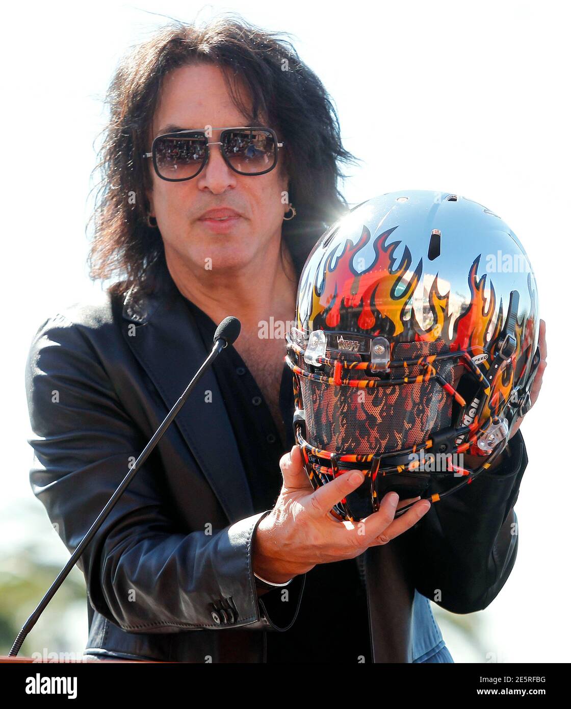 Musician Paul Stanley of rock band Kiss displays a new helmet at a news conference to announce their part-ownership of an Arena Football League team, the Los Angeles Kiss, in Anaheim, California March 10, 2014. The LA Kiss will play their home games in Anaheim and the season kick-off will include a concert by KISS. REUTERS/Alex Gallardo (UNITED STATES - Tags: ENTERTAINMENT SPORT) Stock Photo