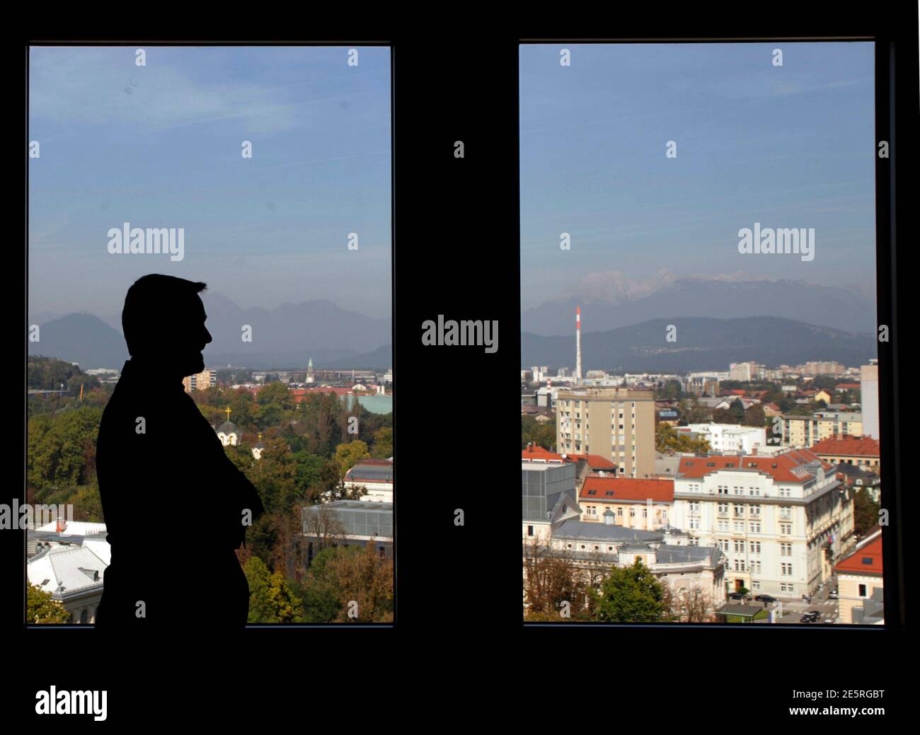 Janko Medja, CEO of NLB bank, is silhouetted as he poses before an interview in Ljubljana September 29, 2014. Slovenia's top bank NLB (Nova Ljubljanska Banka) is likely to pass an EU-wide stress test after nearly collapsing under bad loans in 2013, but the government must press on with selling state assets to ensure stability, Medja said. REUTERS/Srdjan Zivulovic (SLOVENIA - Tags: BUSINESS) Stock Photo