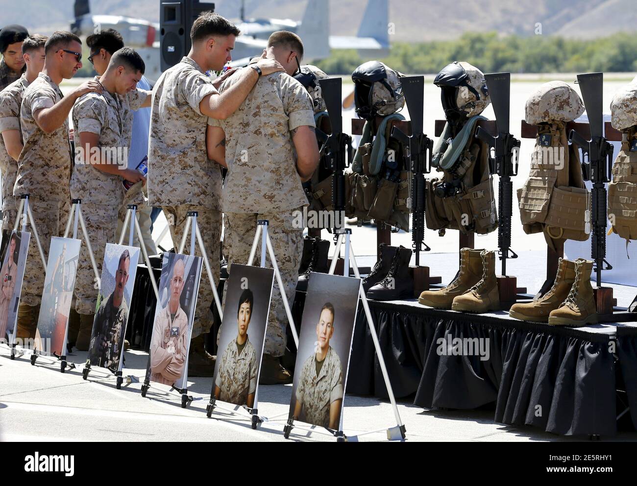 Fellow marines pay their respects to members of the 3rd Marine Aircraft Wing, who were killed in the crash of their military helicopter while coming to the aid of earthquake victims in Nepal, during a memorial service at Camp Pendleton, California June 3, 2015. REUTERS/Mike Blake Stock Photo