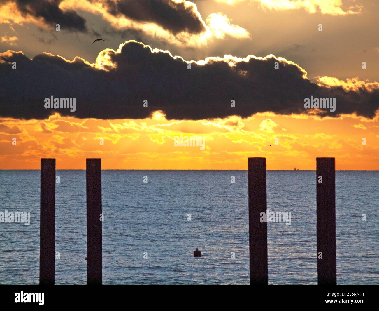 the-sun-goes-down-close-to-the-remains-of-the-old-west-pier-brighton