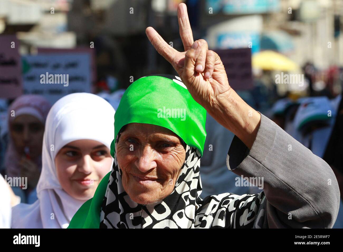 A woman flashes the victory sign as she demonstrates with others from the Islamic Action Front and other opposition parties to demand political reforms, in Amman October 5, 2012. Thousands of Jordanian Islamist supporters marched on Friday in the largest demonstration since Arab Spring-inspired protests erupted last year, calling on King Abdullah to accelerate democratic reforms. The 'Friday to Rescue the Nation' rally was called by the Muslim Brotherhood, the largest opposition party, to push for their demands for broader political representation and a more democratic parliament.  REUTERS/Muh Stock Photo