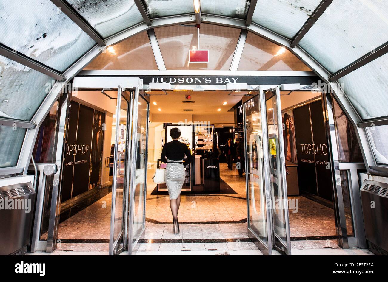 A woman walks through the doors at the Hudson's Bay Company (HBC) flagship  department store in Toronto January 27, 2014. Hudson's Bay Co said on  Monday that it would sell its flagship