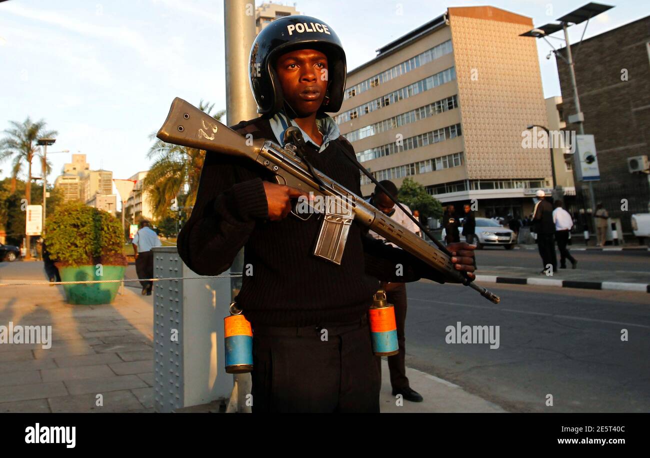 A riot policeman stands guard outside the main gate of the National Assembly in Kenya's capital Nairobi, December 18, 2014. Kenya's parliament approved new anti-terrorism laws on Thursday in the face of vocal protests by some opposition lawmakers who said the measures threatened civil liberties and free speech, legislators said. REUTERS/Thomas Mukoya (KENYA - Tags: POLITICS CIVIL UNREST) Stock Photo