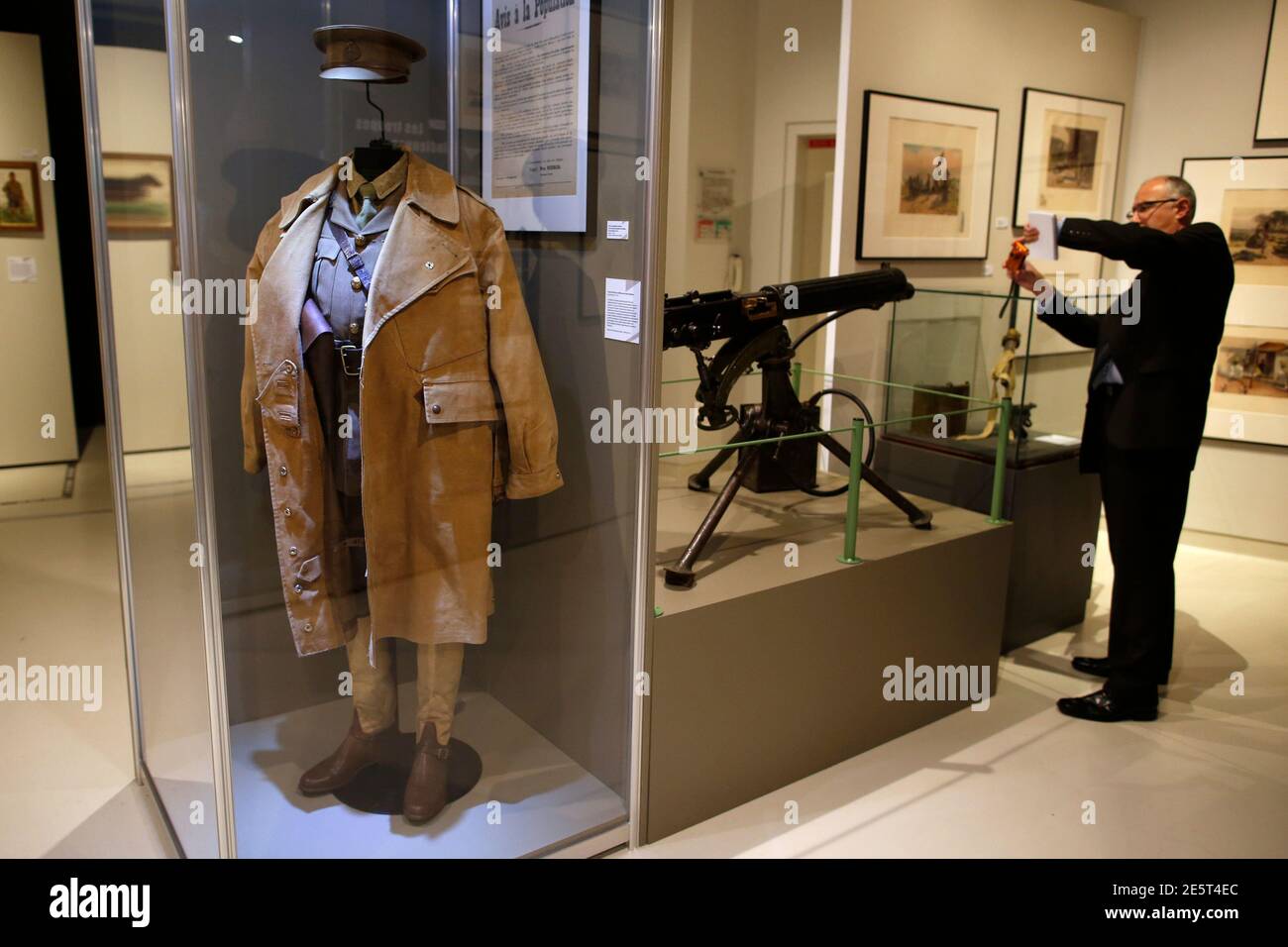 An officer's uniform that includes a Burberry trench coat and a Mark I  Vickers machine gun are displayed in the exhibition "Join Now! The British  Empire's Entry into The War" at the
