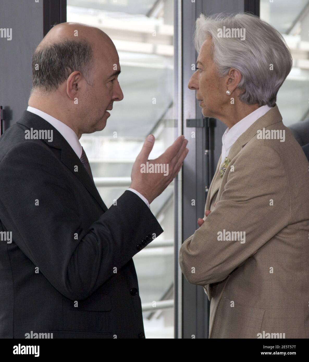 European Economic Commissioner Pierre Moscovici (L) talks with  International Monetary Fund (IMF) Managing Director Christine Lagarde at a  meeting before the arrival of Greek Prime Minister Alexis Tsipras in  Brussels, Belgium, June