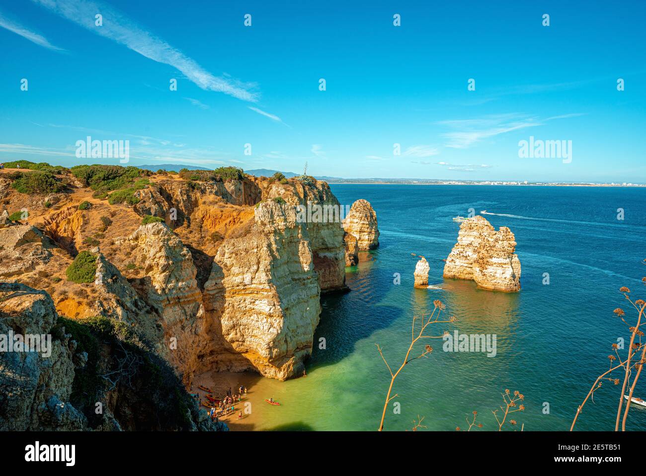 Beautiful landscape from Algarve (Portugal), summer sky with ocean waves, sand and cliff/rocks. Sandy Portuguese beach in the south coast. Stock Photo