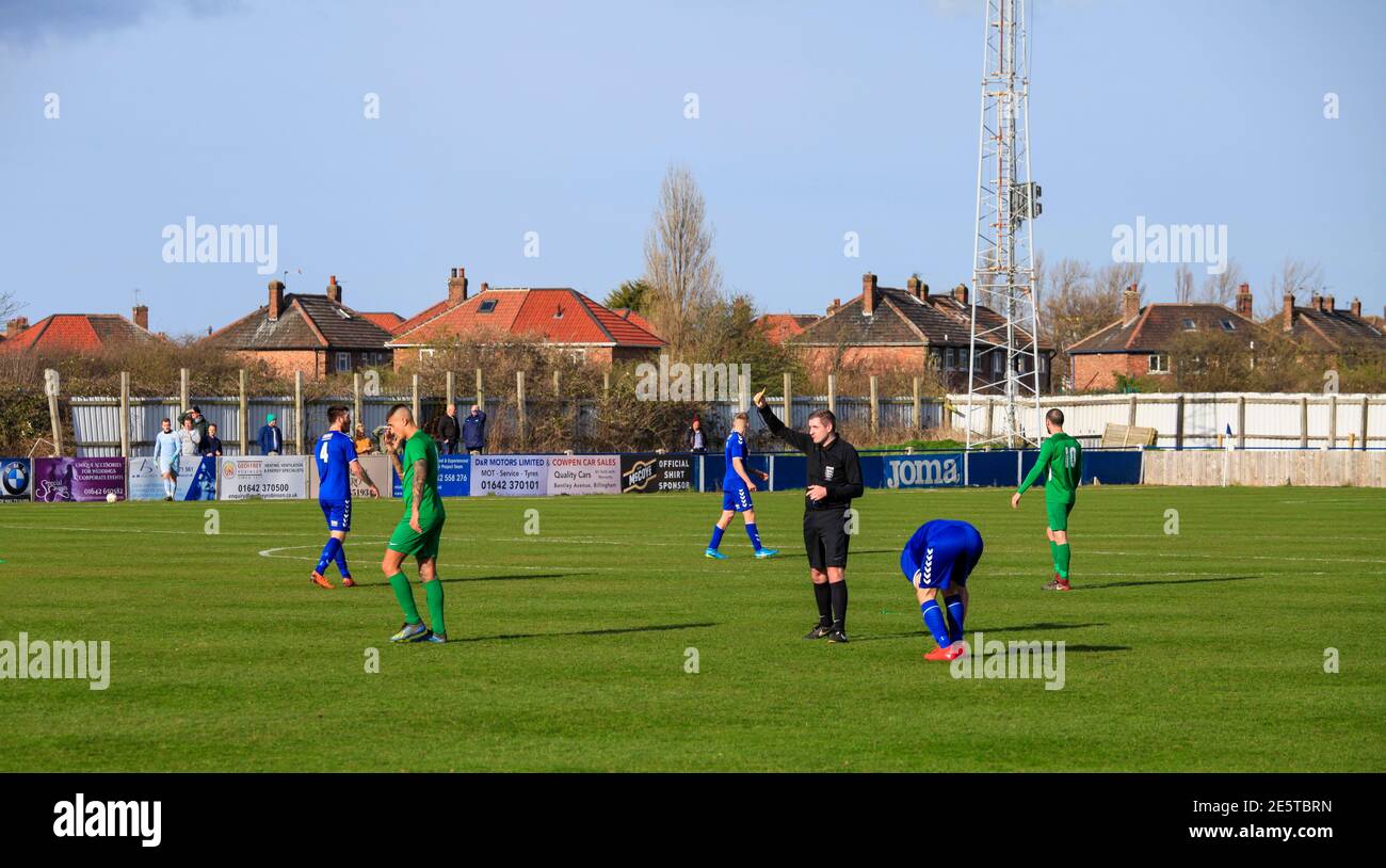 Local amateur football match between Billingham Town and Easington Colliery in north east England,UK. Referee shows yellow card as he books the player. Stock Photo