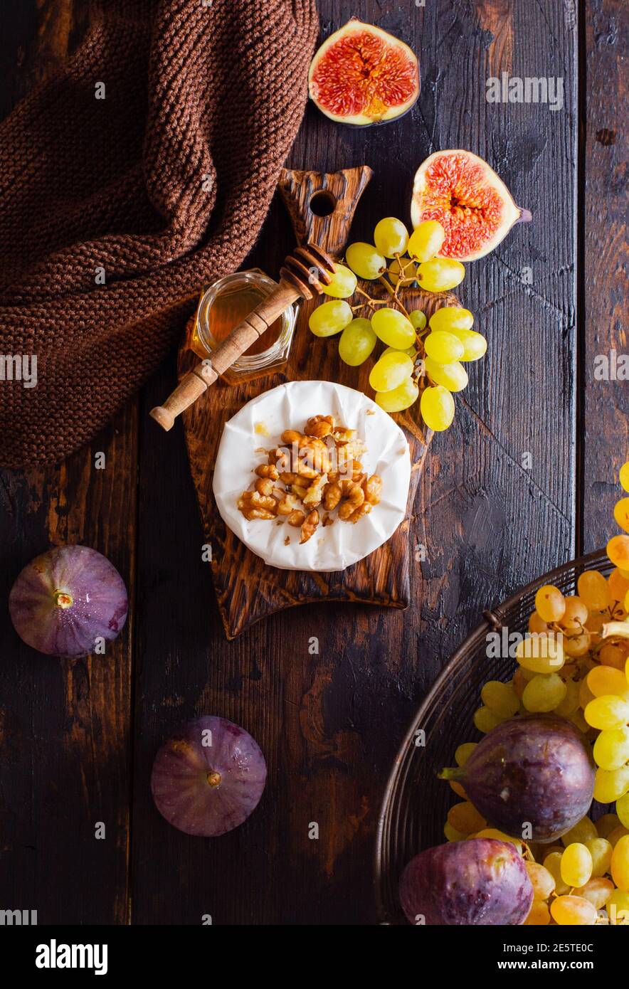 Vintage retro concept. Fresh grapes and figs on an old wooden background in retro style. Top view. Stock Photo