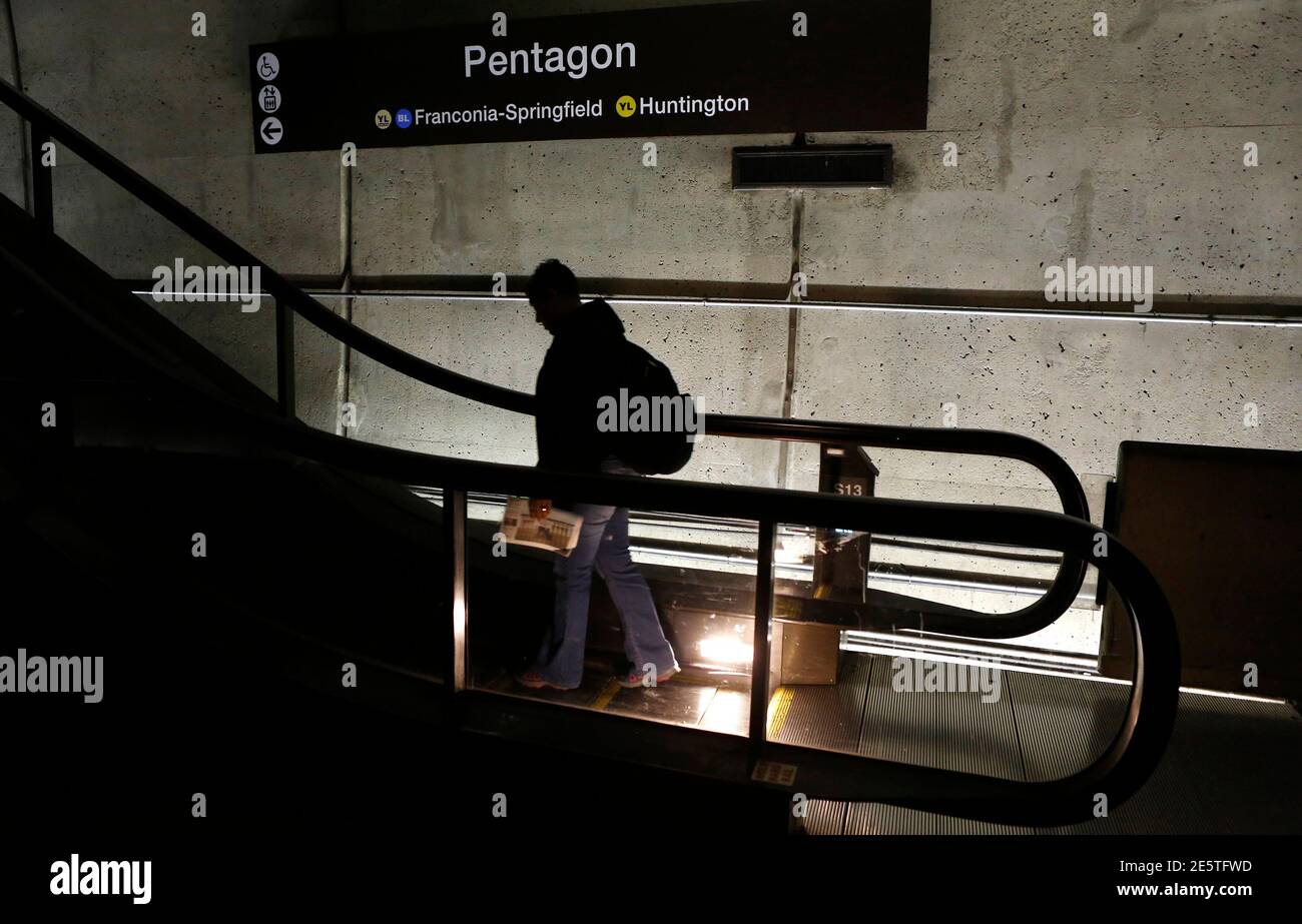 A man rides an upward escalator at the Pentagon Metro station in Washington October 2, 2013. Up to one million federal workers were thrown temporarily out of work on Tuesday as the U.S. government partially shut down for the first time in 17 years in a standoff between President Barack Obama and congressional Republicans over healthcare reforms. REUTERS/Kevin Lamarque  (UNITED STATES - Tags: POLITICS BUSINESS) Stock Photo