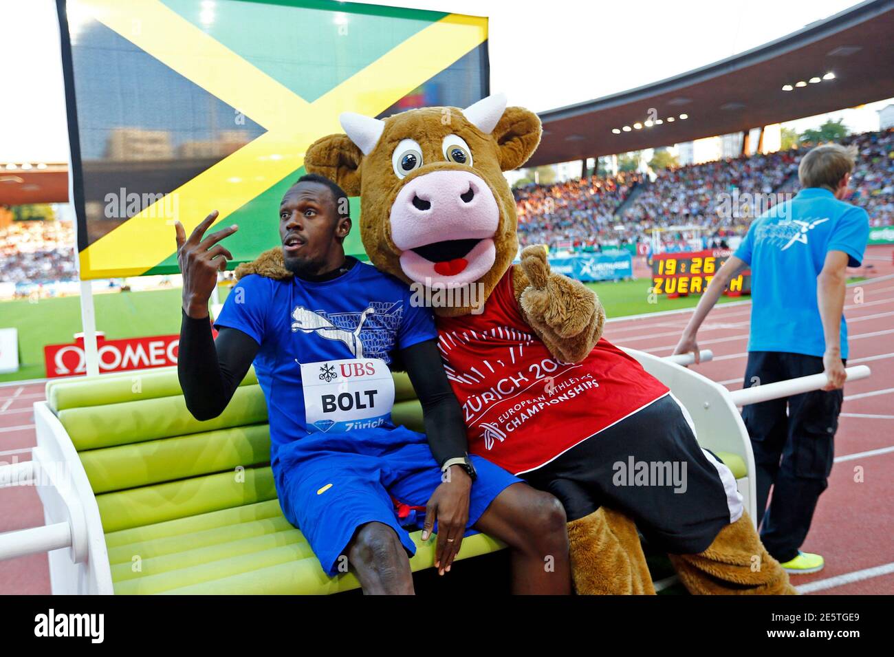 Usain Bolt of Jamaica gestures next to Cooly, the 2014 European Athletics  Championships mascot during the