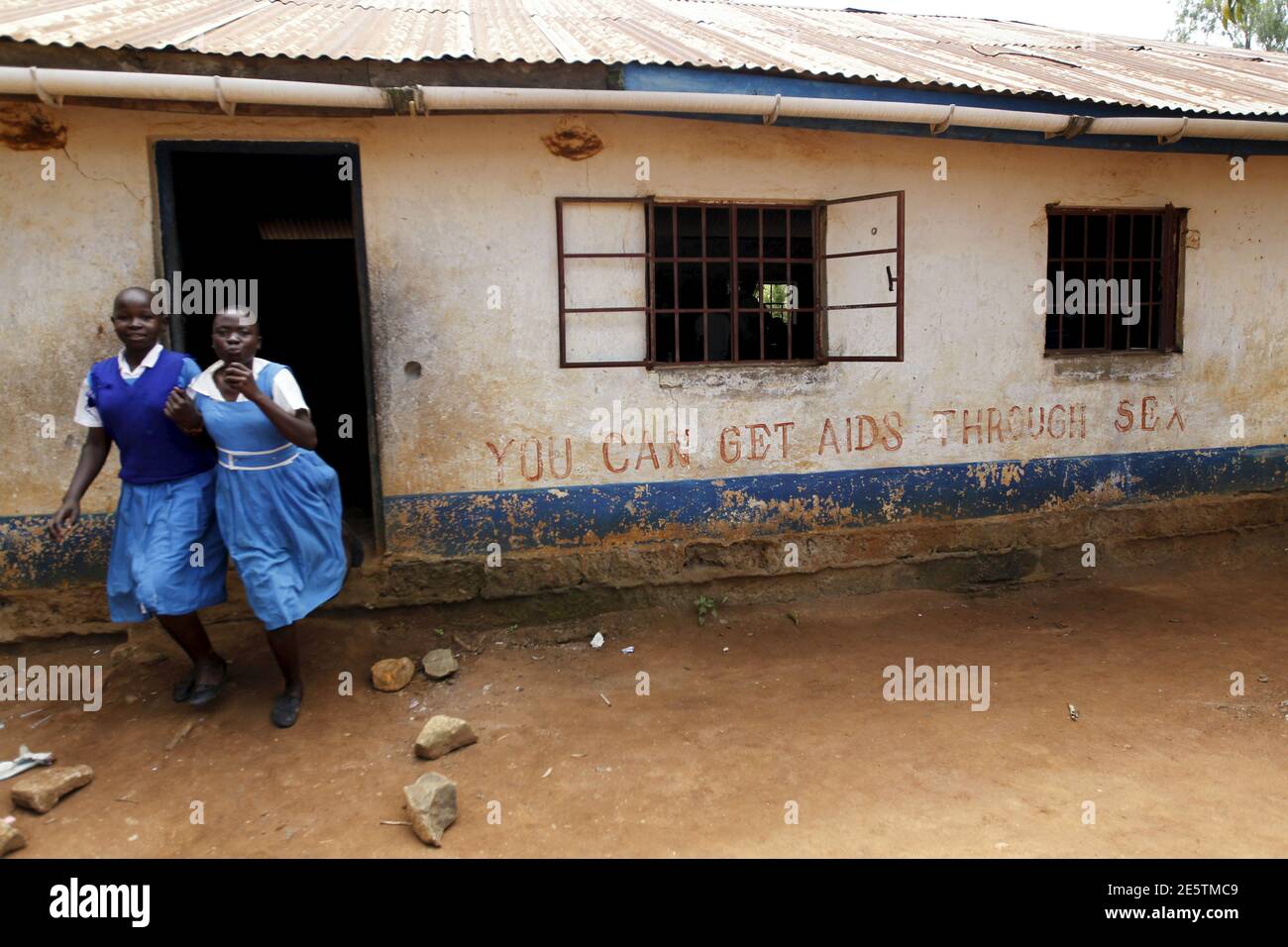Schoolgirls run from a classroom during breaktime at the Senator Barack Obama primary school near Kogelo village west of Kenya's capital Nairobi, June 23, 2015. U.S. President Barack Obama visits Kenya and Ethiopia later this month. His ancestral home of Kogelo is home to Sarah Hussein Obama, his step-grandmother. The Kenyan village, burial place of Obama's father, features an open-pit goldmine, a pork butcher's, a school named after their most famous son and outdoor market stalls. Villagers get around by motorbike taxi or on foot while a donkey-cart transports water. Children, some of them na Stock Photo
