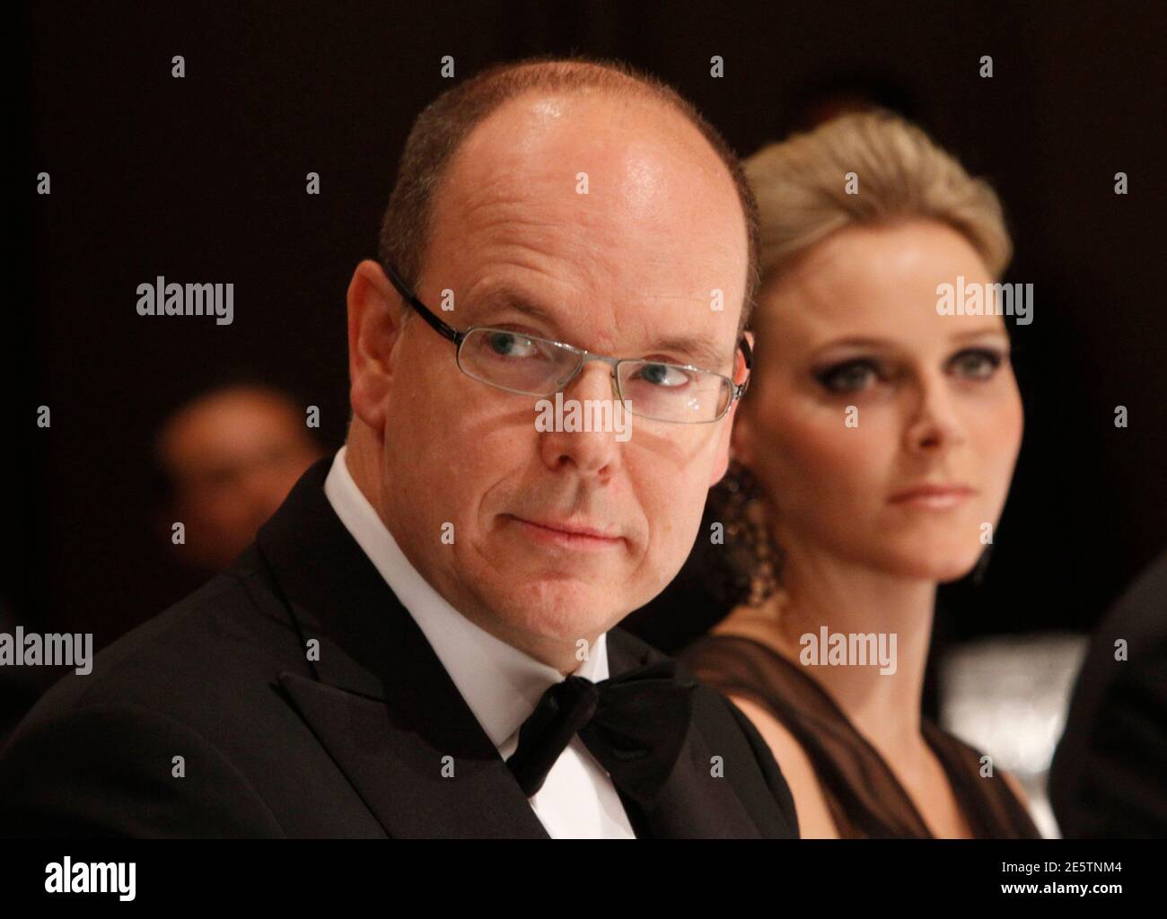 Monaco's Prince Albert II (L) and his fiancee Charlene Wittstock attend at a gala dinner hosted by BirdLife International in Tokyo October 29, 2010. REUTERS/Issei Kato (JAPAN - Tags: ENTERTAINMENT PROFILE ROYALS) Stock Photo