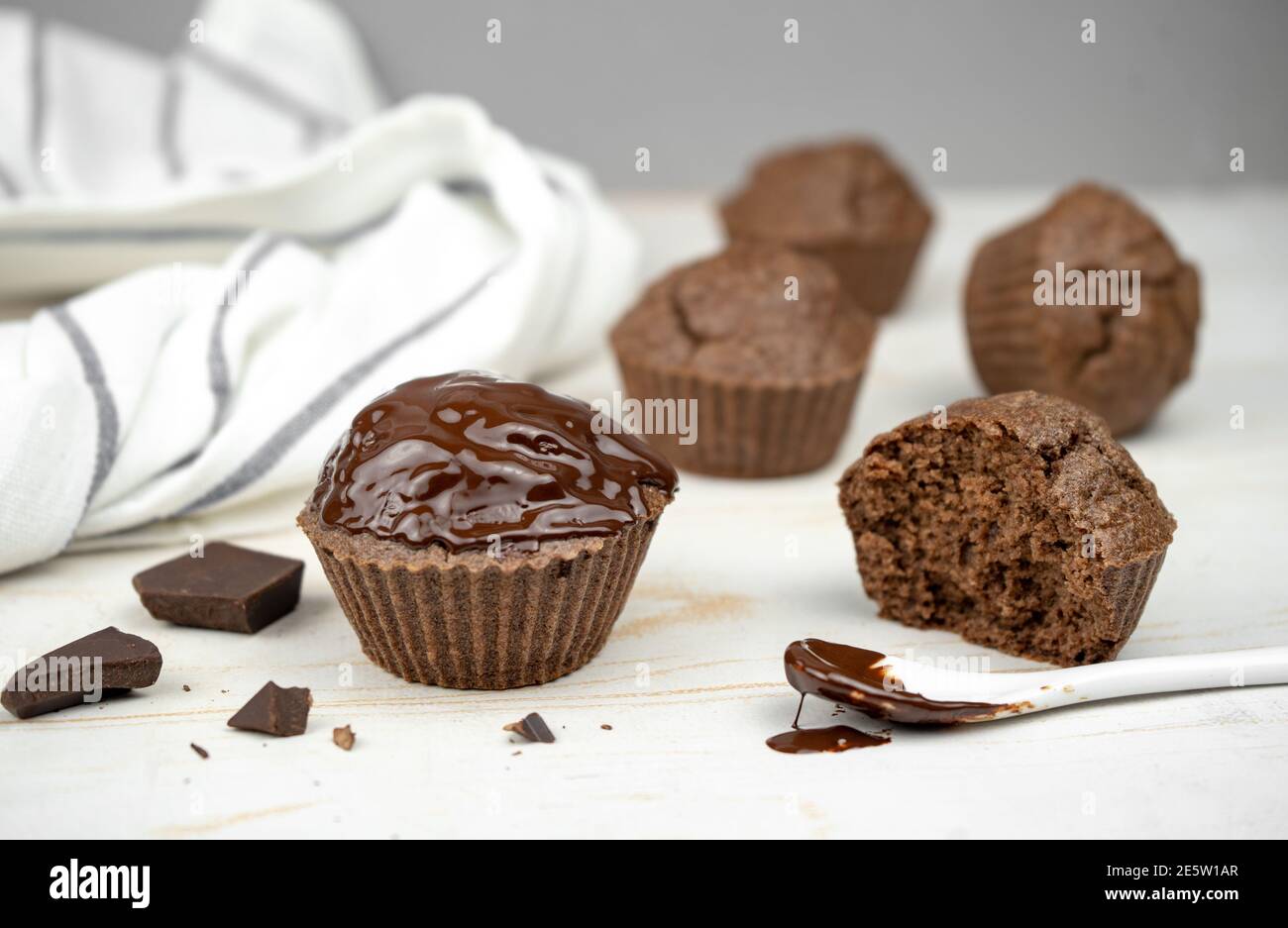 Homemade chocolate brown muffins on white table Stock Photo