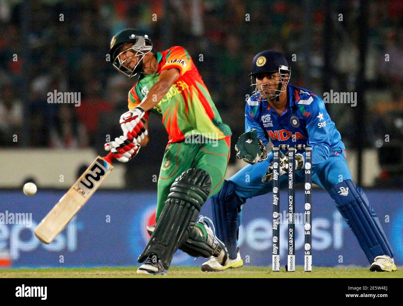 Bangladesh S Nasir Hossain Plays A Ball As India S Captain And Wicketkeeper M S Dhoni R Watches During Their Icc Twenty World Cup Match At The Sher E Bangla National Cricket Stadium In Dhaka March 28