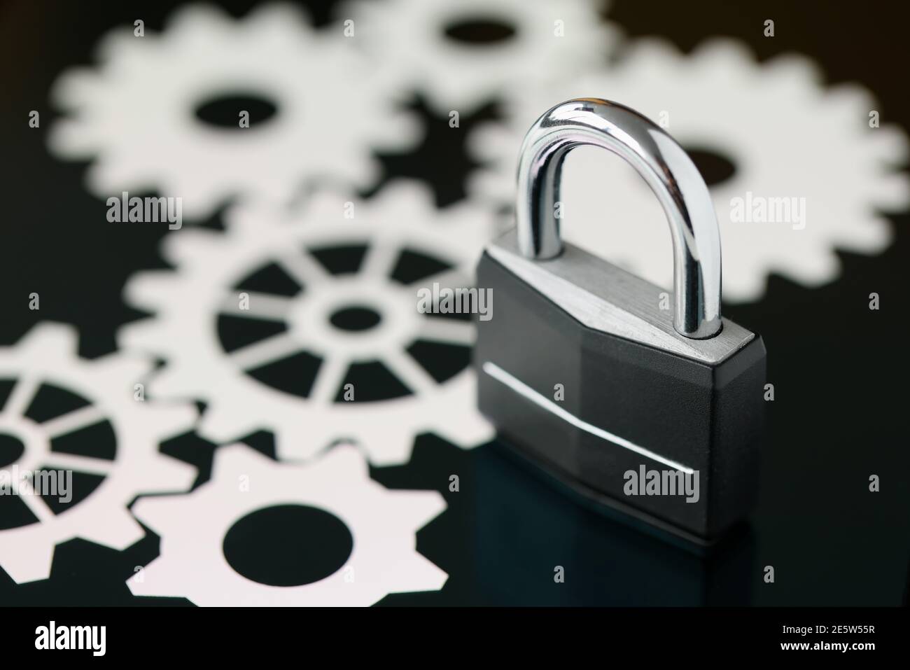 Black metal padlock standing on tablet screen closeup Stock Photo