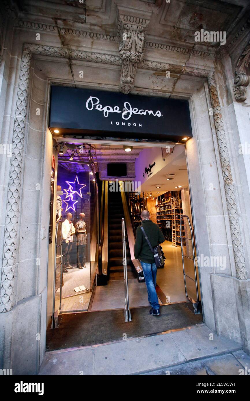 A man walks in a Pepe Jeans store in Barcelona December 2, 2014. The Qatari  royal family is leading the race to buy the Spanish fashion brand Pepe Jeans  as buyout funds