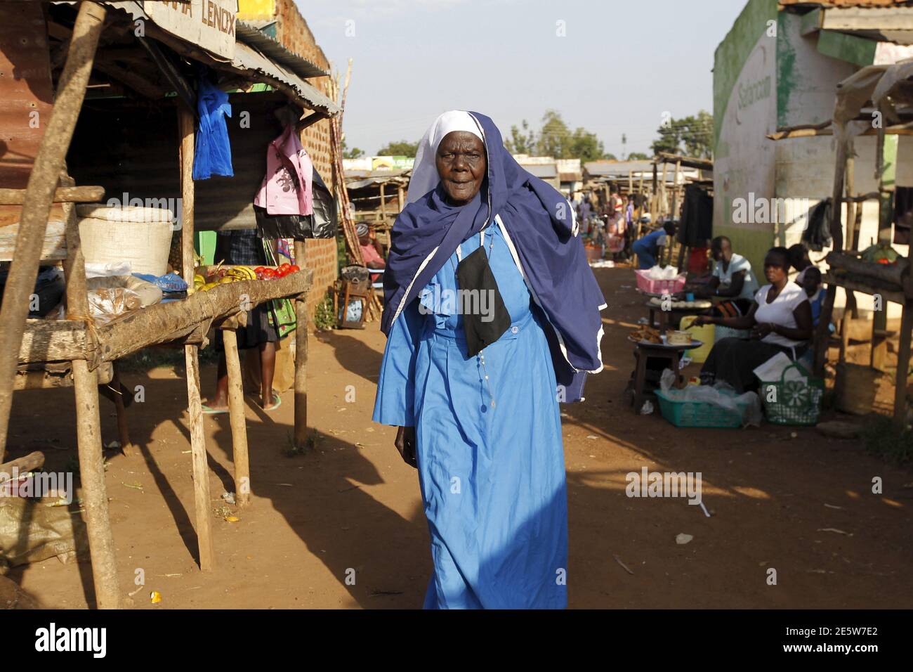 Clementina Auma Ojwang, a religious leader of the Legio Maria - a Spirit Initiated Church, walks at the trading centre the U.S. President Barack Obama's ancestral village of Nyang'oma Kogelo, west of Kenya's capital Nairobi, July 15, 2015. Auma, 87, said we are proud of better roads, improved security, tarmac roads and business opportunities since Barack Obama became the U.S. President. 'The current challenge we are facing as the people of Nyang'oma Kogelo is quality education and access to financial capital' she added. President Obama visits Kenya and Ethiopia in July, his third major trip to Stock Photo