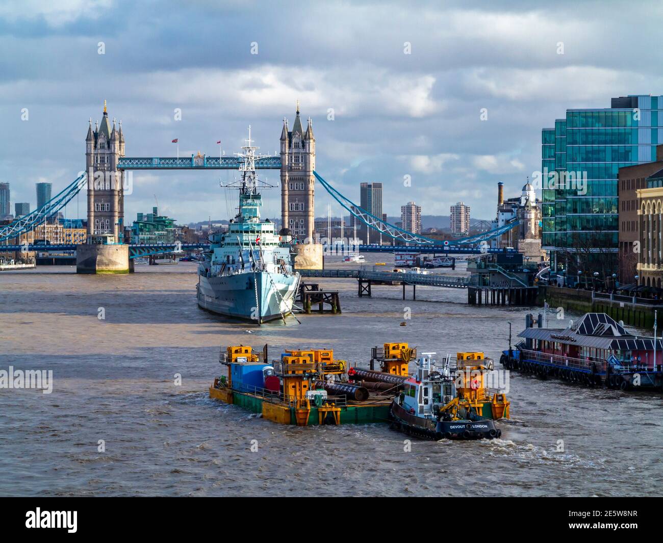 Tower Bridge and HMS Belfast a British Royal Navy  light cruiser launched in 1936 now a floating museum ship on the River Thames in London England UK Stock Photo