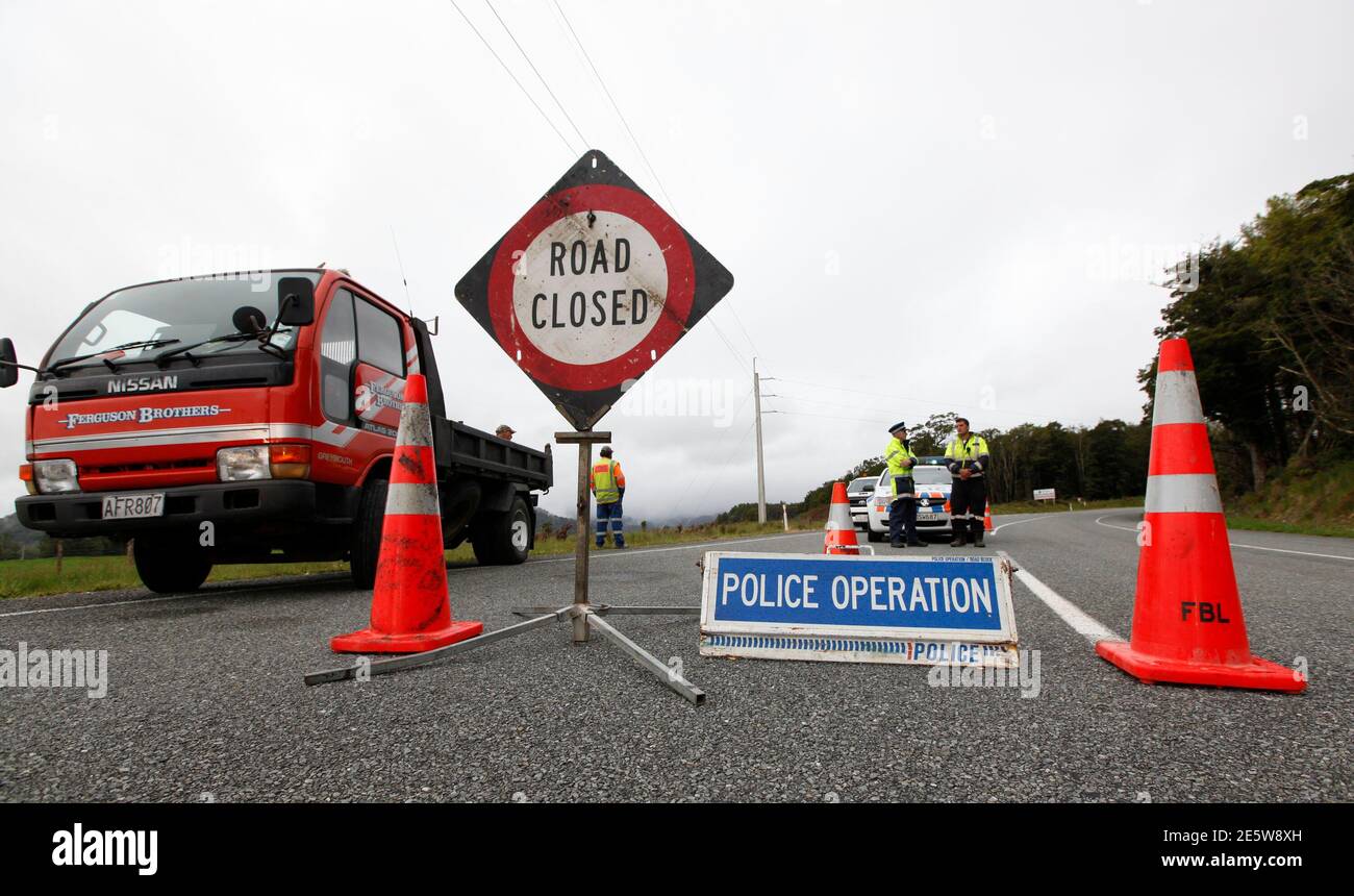 New Zealand policemen stand at a road block on the road leading to the Pike River coal mine November 20, 2010, where 29 miners are trapped following an underground explosion on Friday. New Zealand rescuers have yet to make contact with the trapped miners as fears of lethal gas levels prevented any chance of a rescue on Saturday, 24 hours after the explosion ripped through the remote colliery dug into the side of a mountain.         REUTERS/Tim Wimborne    (NEW ZEALAND - Tags: DISASTER) Stock Photo