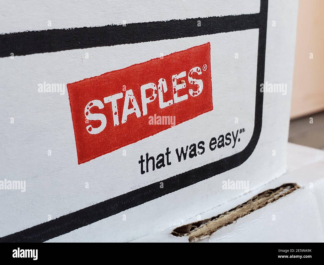 Closeup of logo for office supply store Staples with tagline That Was Easy on cardboard file