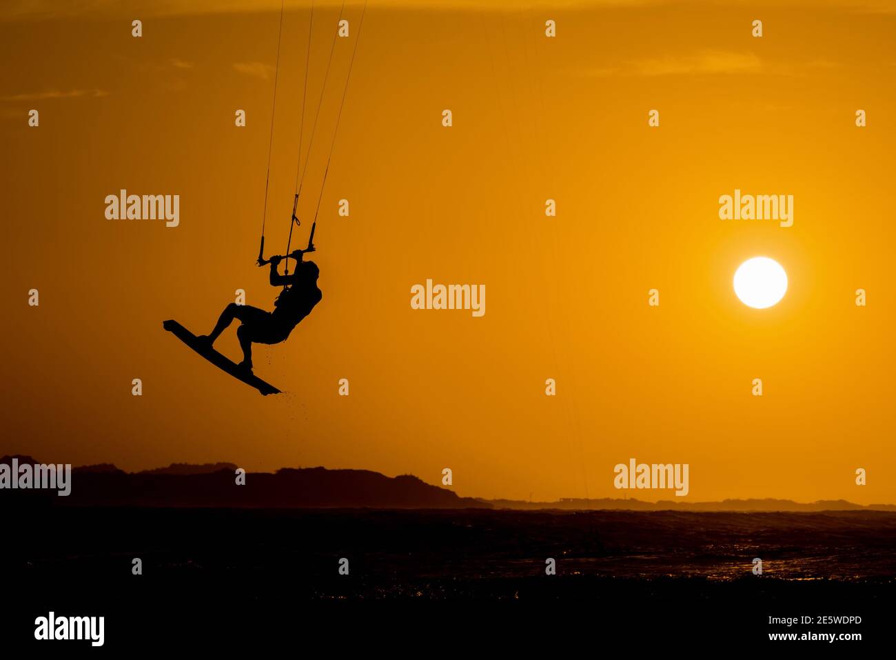 kitesurfer athlete rider jumping at sunset kiteboarding jump Stock Photo Alamy