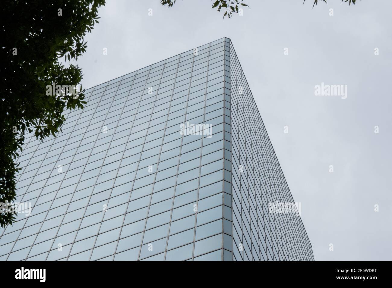 Tall office building with cloudy sky as background Stock Photo - Alamy