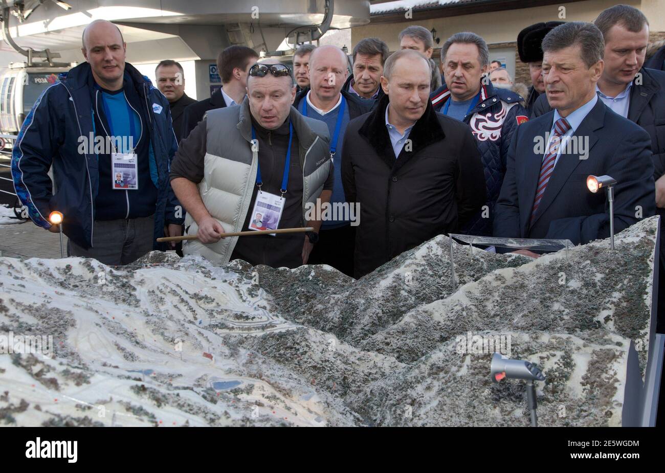 Russia's President Vladimir Putin (2nd R) listens to Interros Company President Vladimir Potanin (2nd L), with Sochi 2014 chief Dmitry Chernyshenko (L) and deputy Prime Minister Dmitry Kozak (R) standing nearby, as he visits the Rosa Khutor Alpine Center in Rosa Khutor outside the Black Sea resort of Sochi, February 6, 2013. Putin on Wednesday toured objects of the Olympic mountain cluster, which will host the 2014 Winter Olympic Games.  REUTERS/Ivan Sekretarev/Pool (RUSSIA - Tags: POLITICS SPORT OLYMPICS BUSINESS) Stock Photo