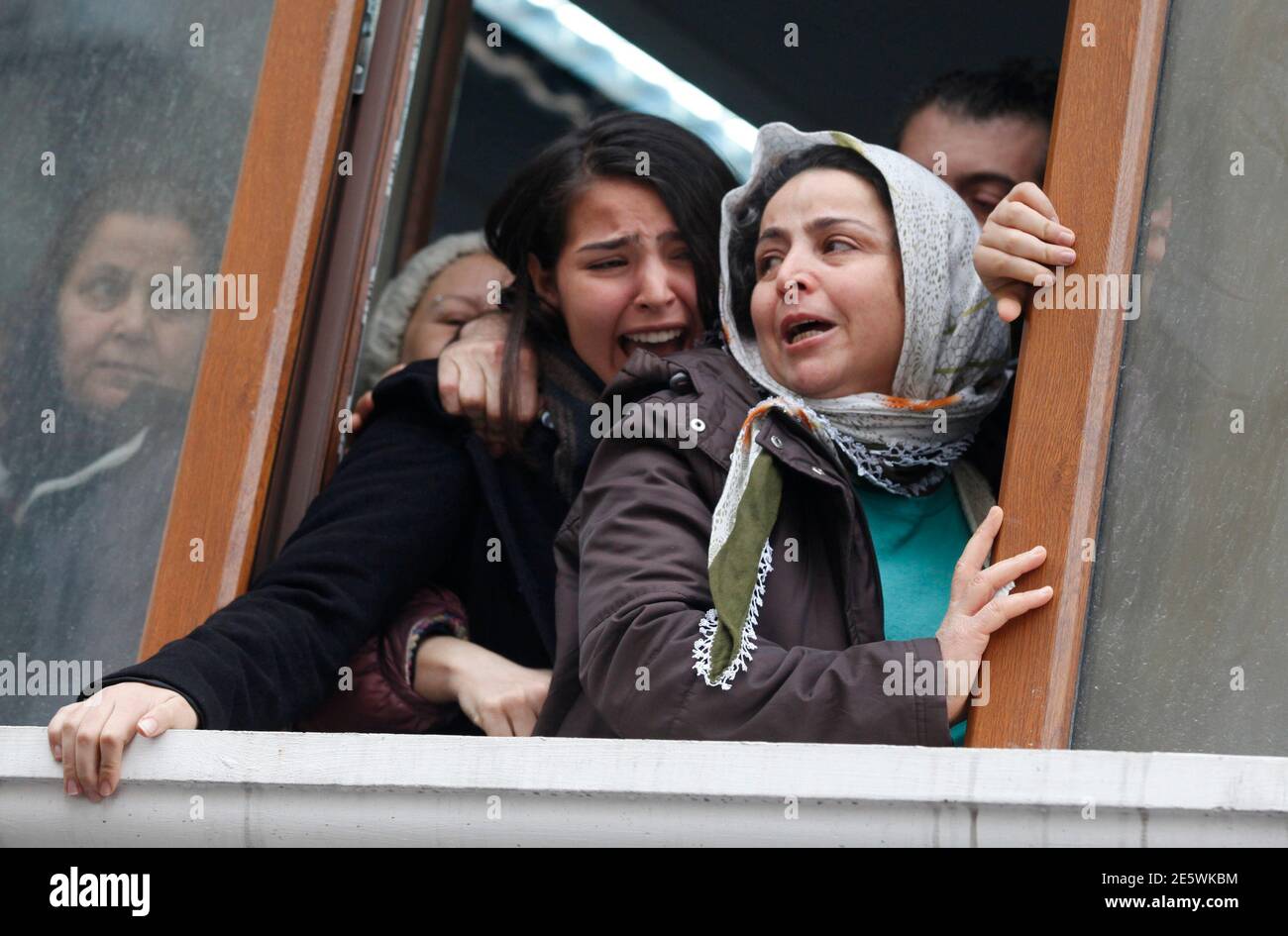 Berkin Elvan's sister Ozge (C) reacts as his coffin approaches the Okmeydani cemevi, an Alevi place of worship, in Istanbul March 11, 2014. Police and protesters clashed in Turkey's two biggest cities on Tuesday following the death of the 15-year-old boy who suffered a head injury during anti-government demonstrations last summer. Elvan, then aged 14, got caught up in street battles in Istanbul between police and protesters on June 16 after going out to buy bread for his family. He was struck in the head by a tear-gas canister and went into a coma. Alevis are a religious minority in mainly Sun Stock Photo