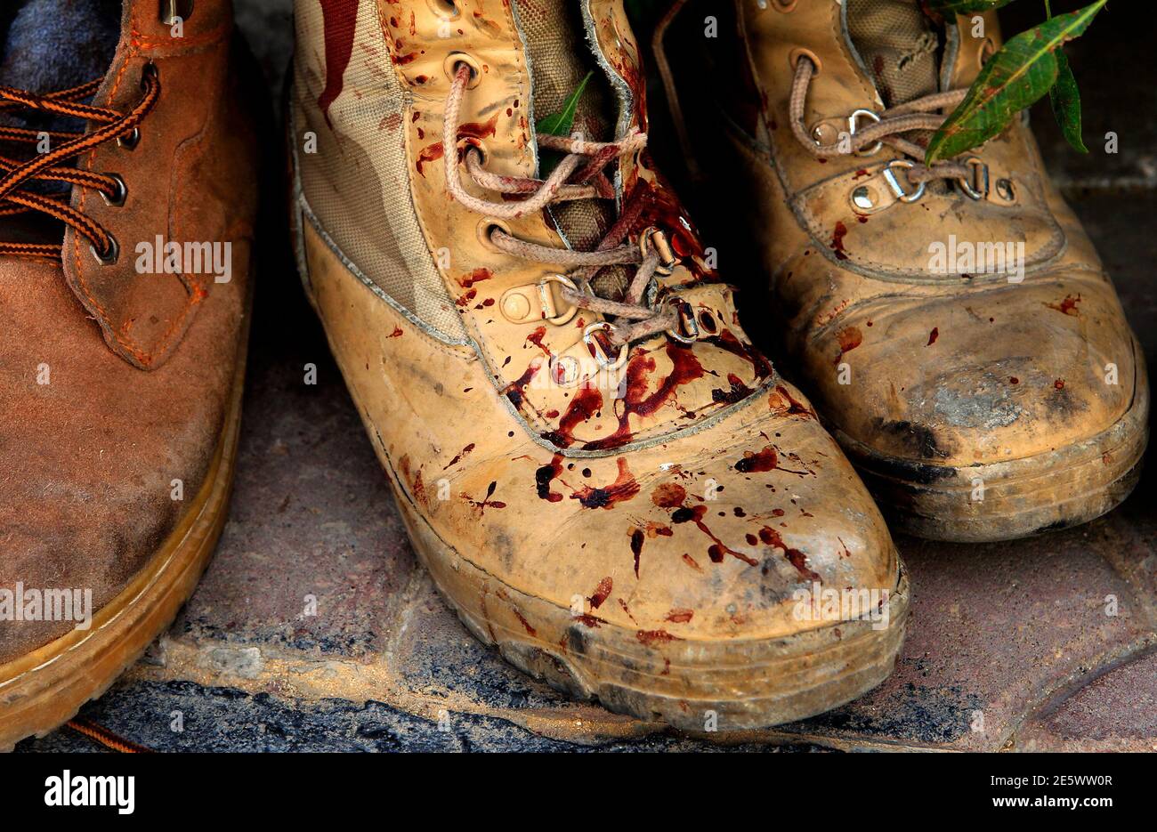 Blood stained boots of a killed rebel fighter are seen outside the  emergency ward of Misrata hospital April 22, 2011. Rebel fighters pushed  Gaddafi forces off the upper part of Tripoli Street