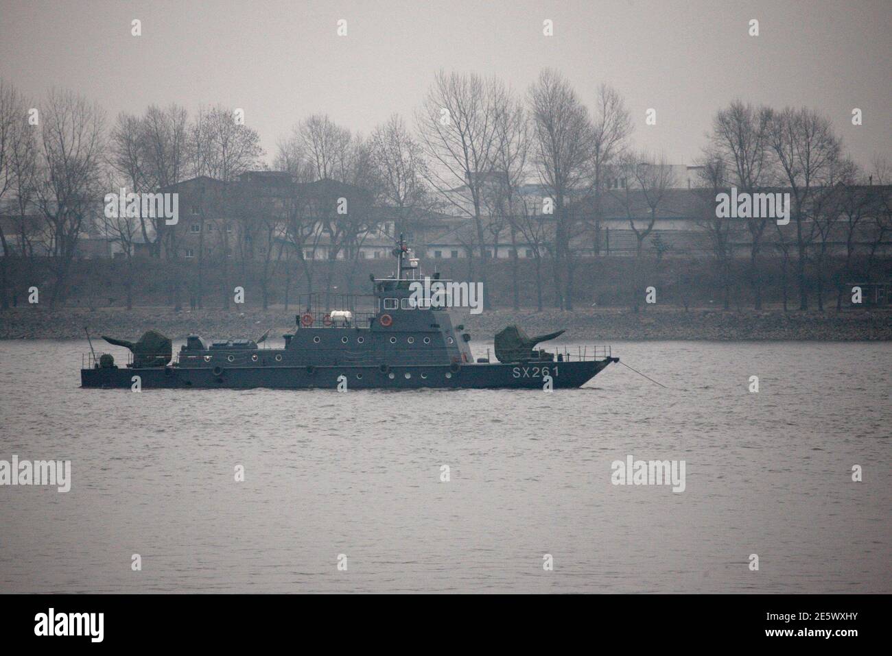 A Chinese military vessel is seen on Yalu River near the North Korean town of Sinuiju, opposite the Chinese border city of Dandong, December 28, 2011. North Korea will hold a funeral procession on Wednesday for its deceased 'dear leader', Kim Jong-il, making way for his son, Kim Jong-un, to become the third member of the family to run the isolated and unpredictable Asian country.   REUTERS/Jacky Chen (NORTH KOREA - Tags: POLITICS OBITUARY) Stock Photo