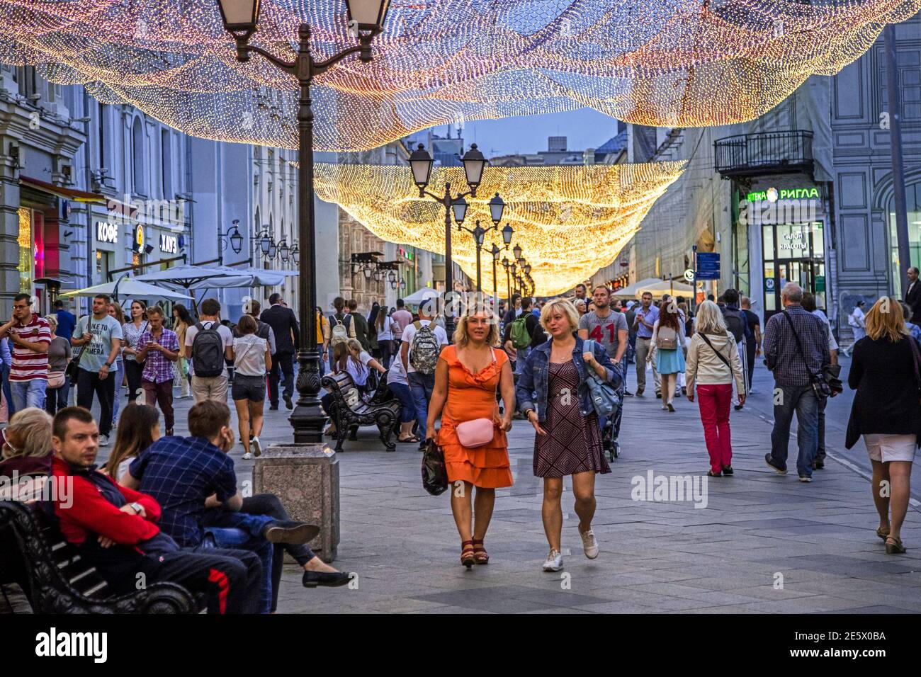 Russian shoppers walking in decorated and illuminated shopping street in the city centre of Moscow at night, Russia Stock Photo