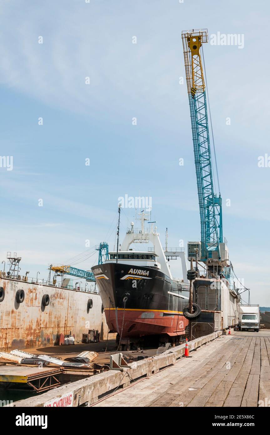 A crane at the moveable drydock at the Port of Anacortes, Washington. Anacortes, Washington.  The ship 'Auriga' is in the drydock. Stock Photo
