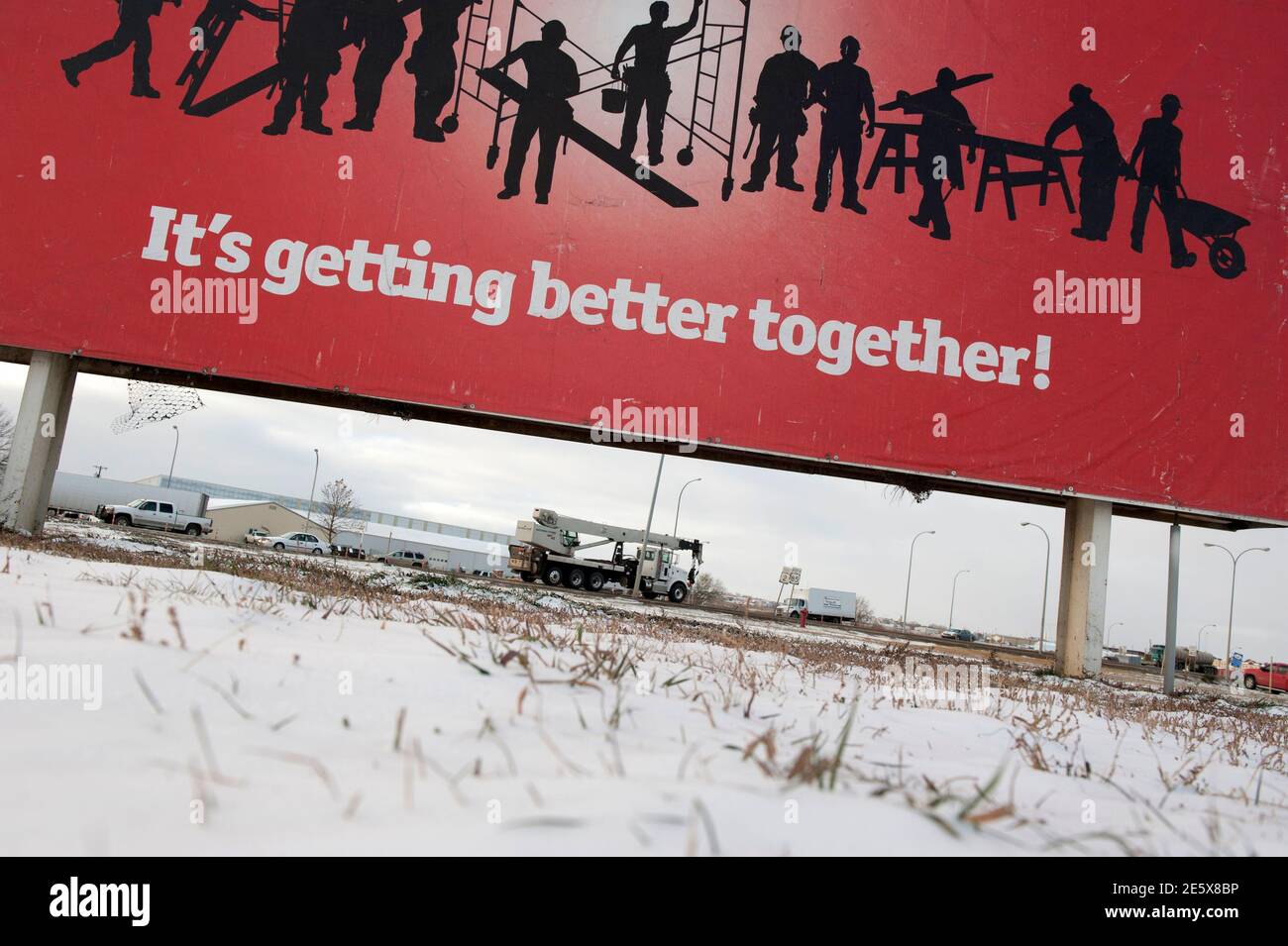 A sign reads 'It's getting better together!' along the main road in Williston, North Dakota November 12, 2014.  Falling oil prices have yet to spoil North Dakota's party, with billions of investment dollars still flowing for new wells and pipelines, apartments and shopping centers, a tacit bet the third energy boom in the state's history is just getting started.   REUTERS/Andrew Cullen (UNITED STATES  - Tags: BUSINESS COMMODITIES ENERGY) Stock Photo