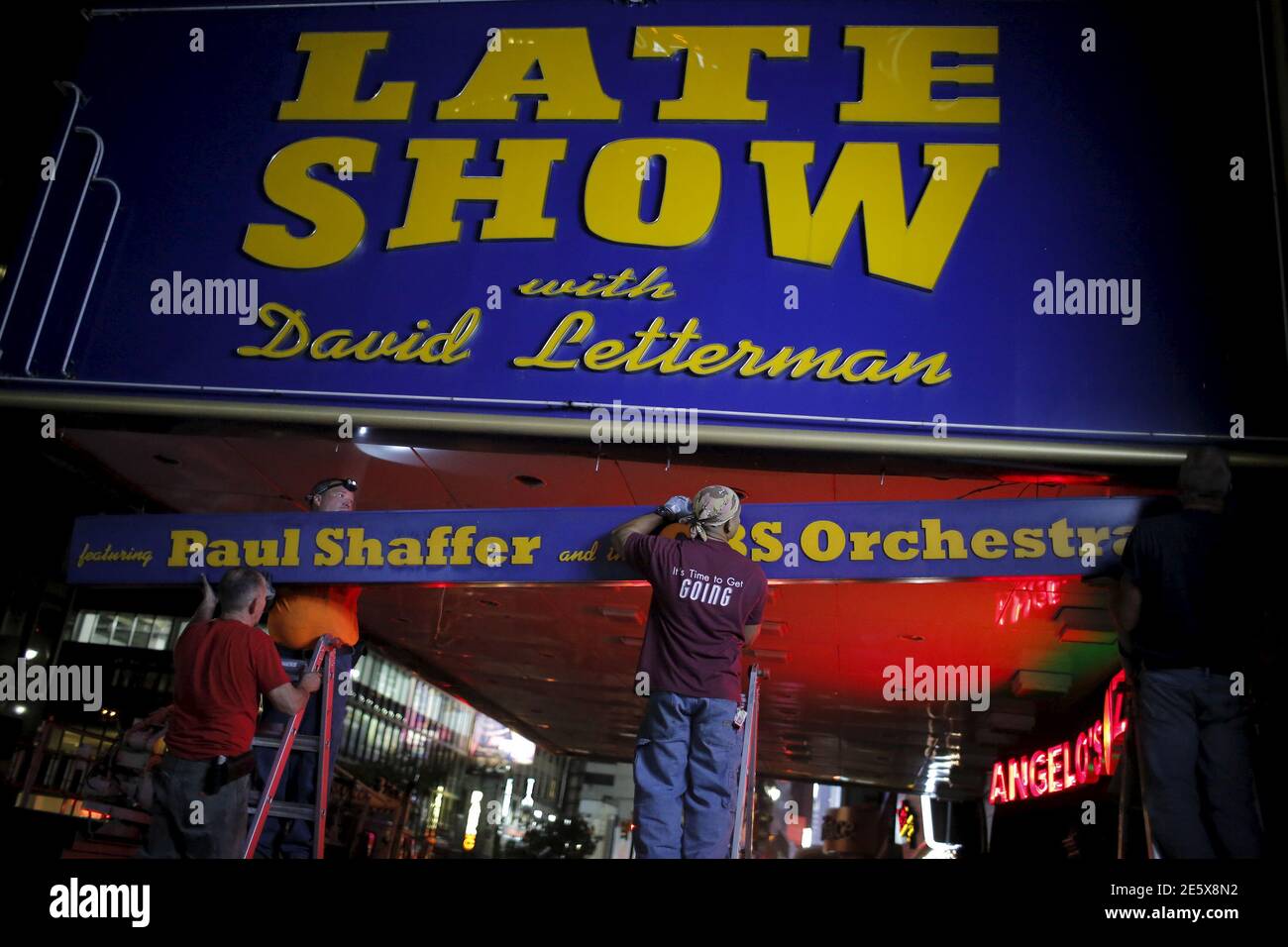 Workers remove part of the marquee for the "Late Show with David Letterman" outside of the Ed Sullivan Theater in Manhattan, New York May 27, 2015. REUTERS/Eduardo Munoz Stock Photo