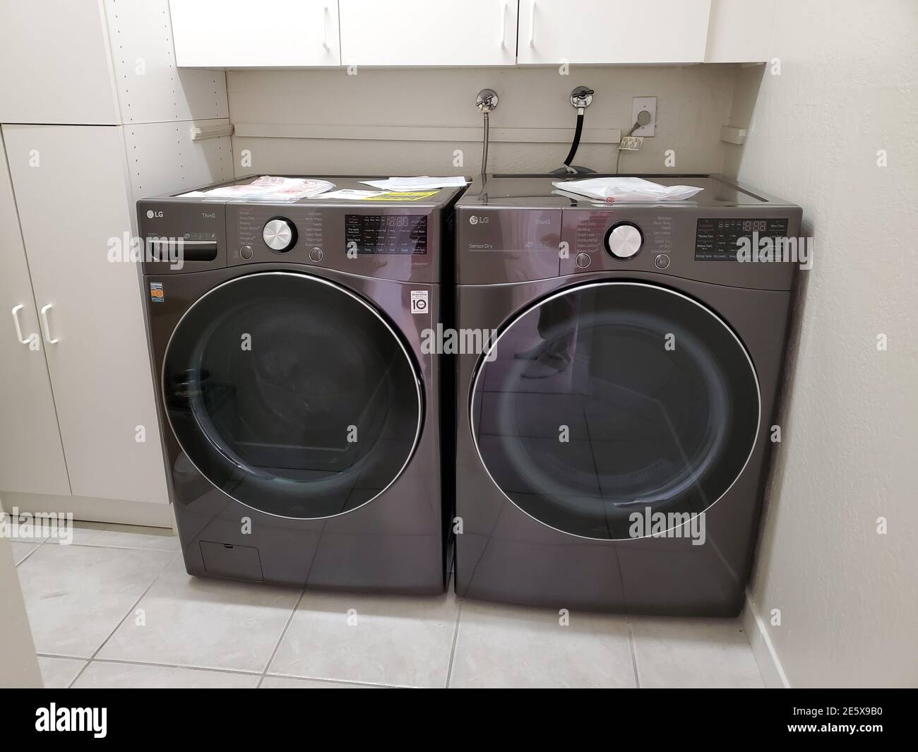Front view of an LG washing machine and dryer side by side in a laundry ...