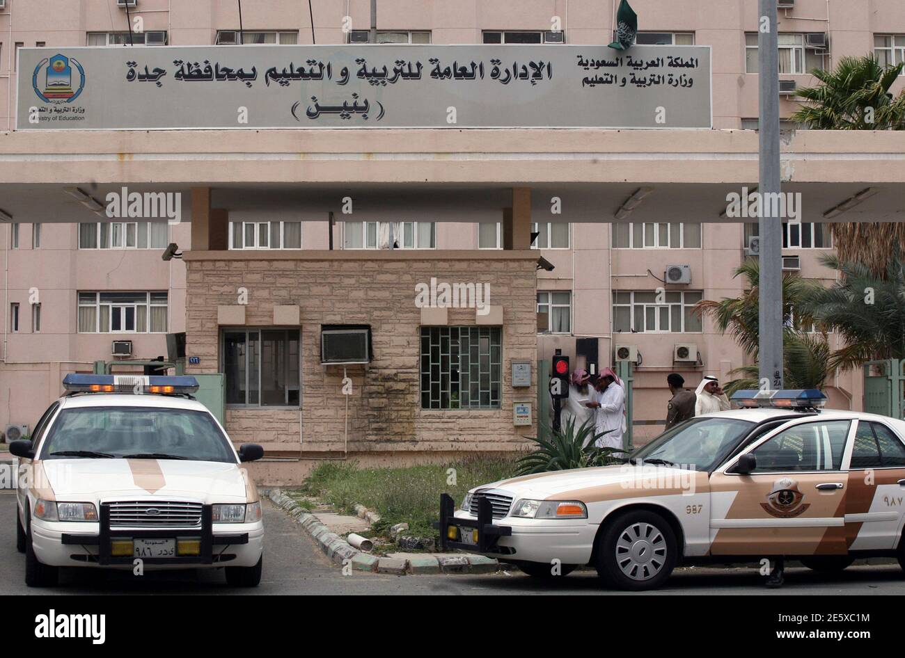 Saudi police vehicles are pictured outside the education ministry office in  Jeddah April 10, 2011. Dozens of unemployed university graduates and  teachers staged rare protests in two Saudi cities on Sunday, demanding