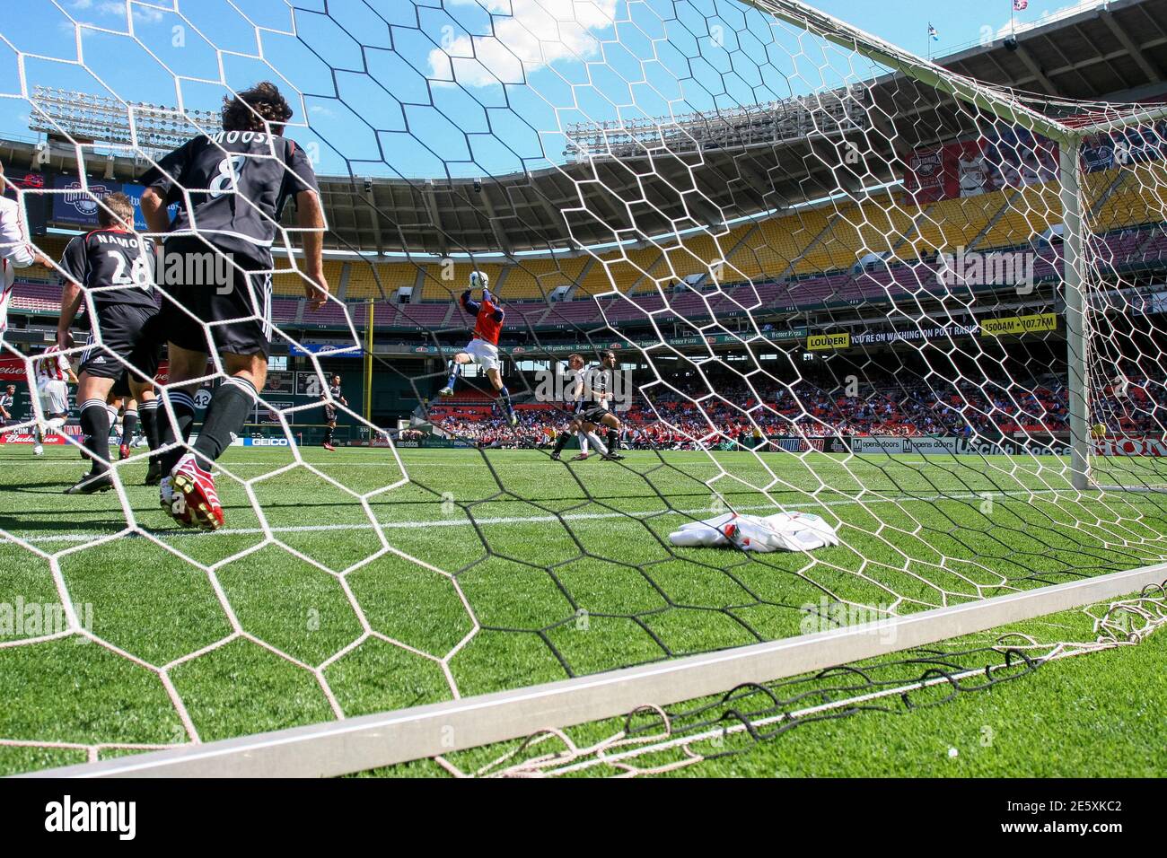 A goalkeeper making a save captured by a remote camera behind the goal