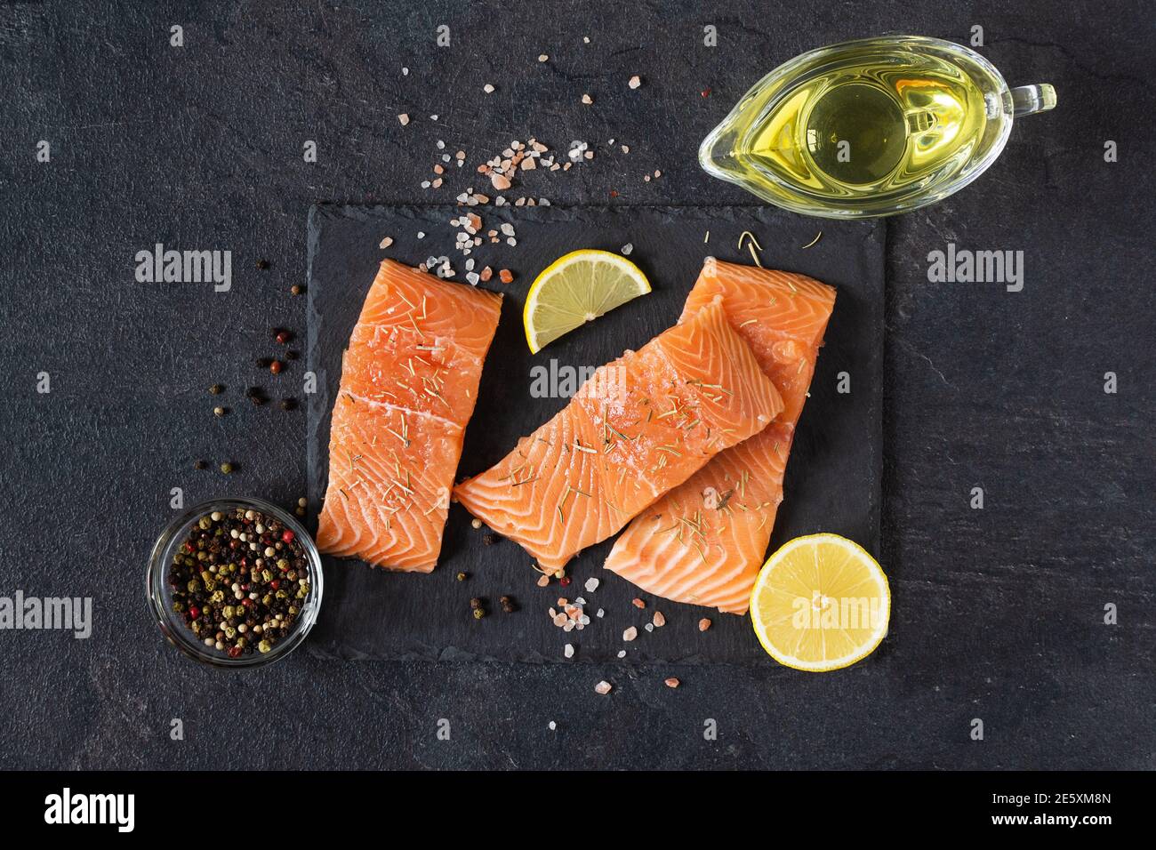 Fresh raw salmon fish fillet with cooking spices, oil and lemon on ...