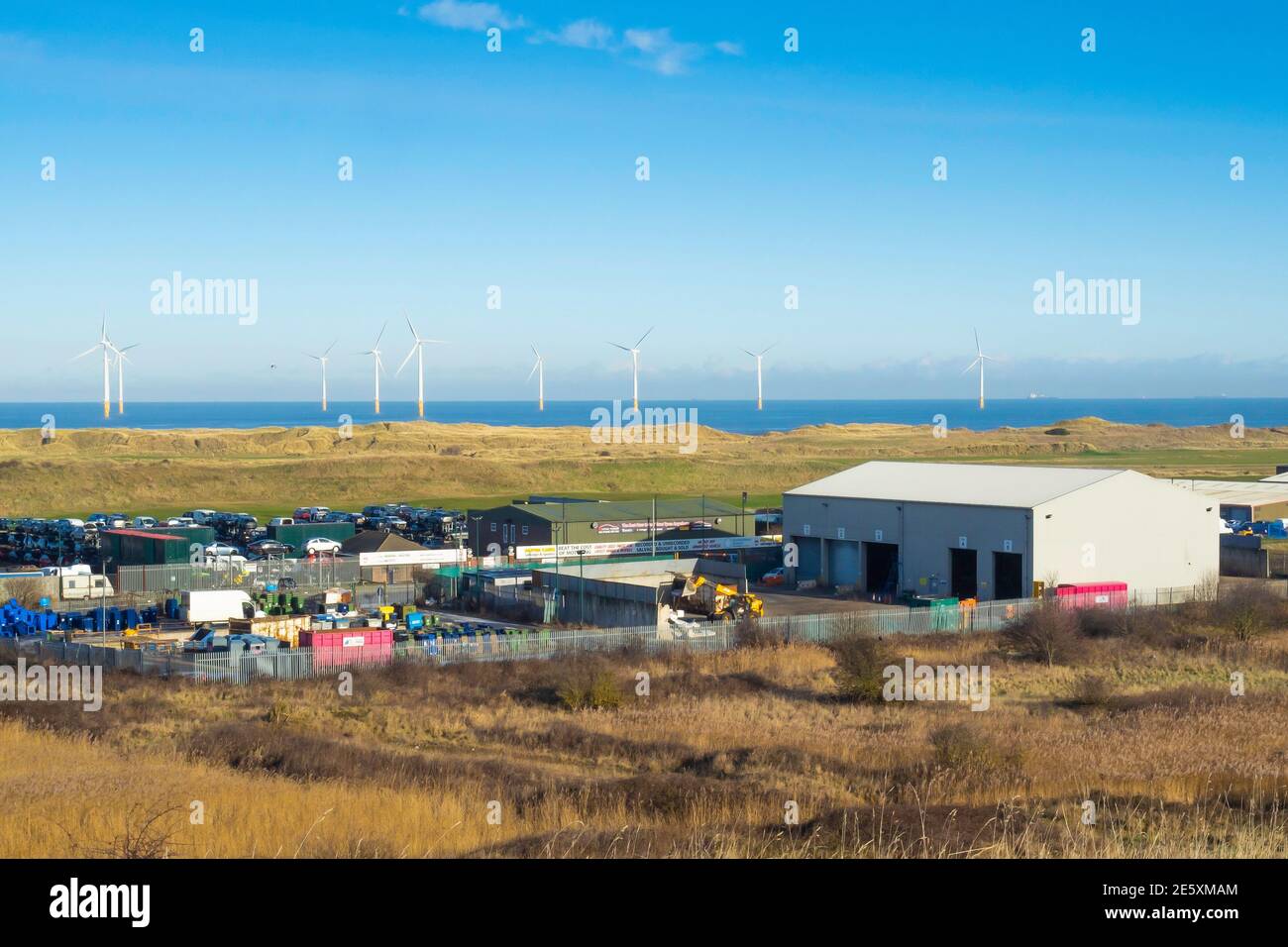 A recycling plant in Warrenby light industrial estate Redcar Cleveland North Yorkshire England UK with a windfarm and golf course behind Stock Photo