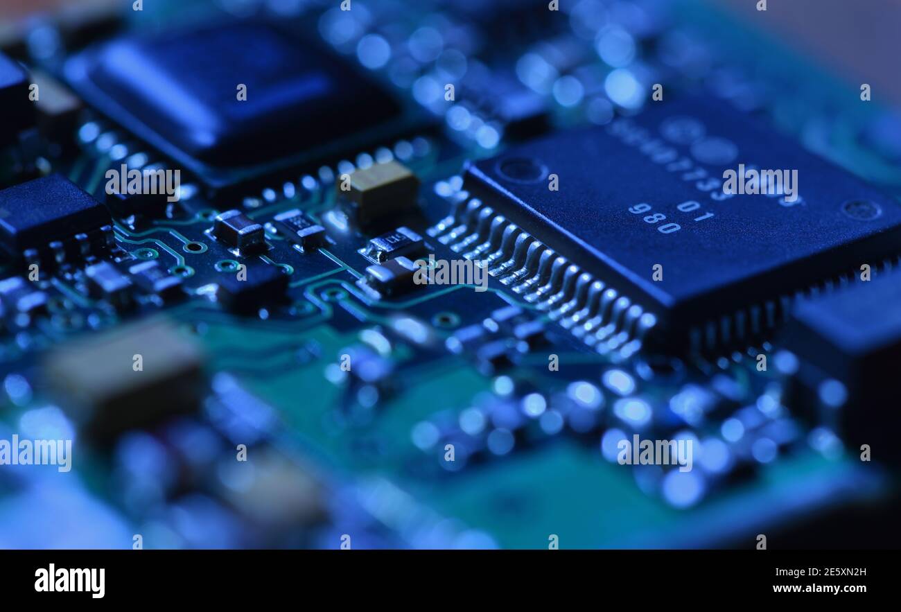 Digital microchip under dramatic blue light close-up Stock Photo