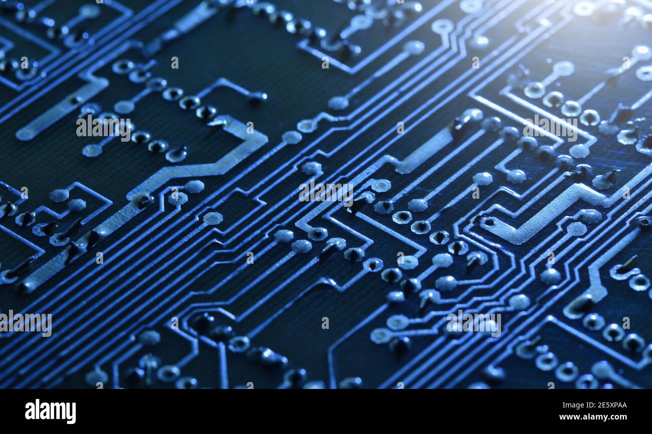 Electronic Circuit Board Under Blue Light As The Technology Background