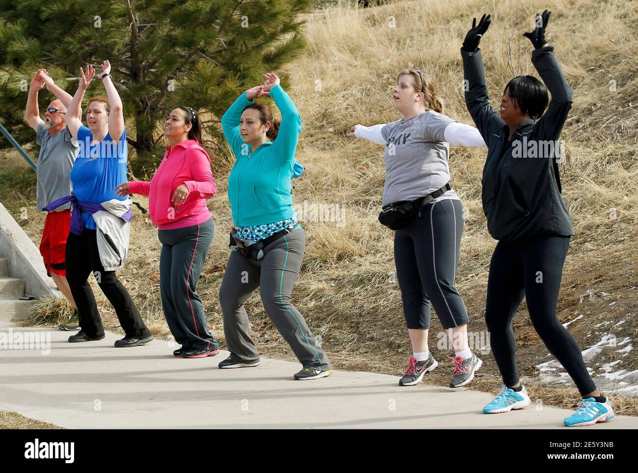 Jazmine Raygoza (C) and her mother Veronica (3rd L),  both bariatric surgery patients, do jumping jacks in a exercise class for bariatric surgery patients in Denver January 28, 2012.  Veronica was 188 lbs and Jazmine 225 lbs on this day.  REUTERS/Rick Wilking  (UNITED STATES - Tags: SOCIETY HEALTH) Stock Photo