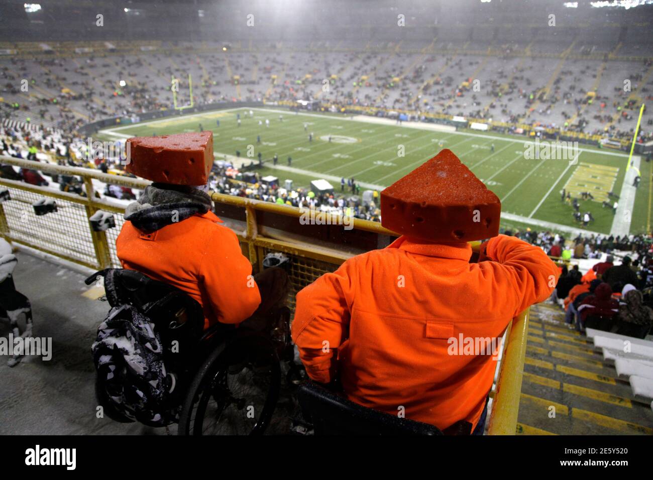 Fans dressed in hunter orange wait in the snow before the NFL football game against the Green Bay Packers and the Detroit Lions in Green Bay, Wisconsin December 9, 2012. REUTERS/Darren Hauck (UNITED STATES - Tags: SPORT FOOTBALL) Stock Photo