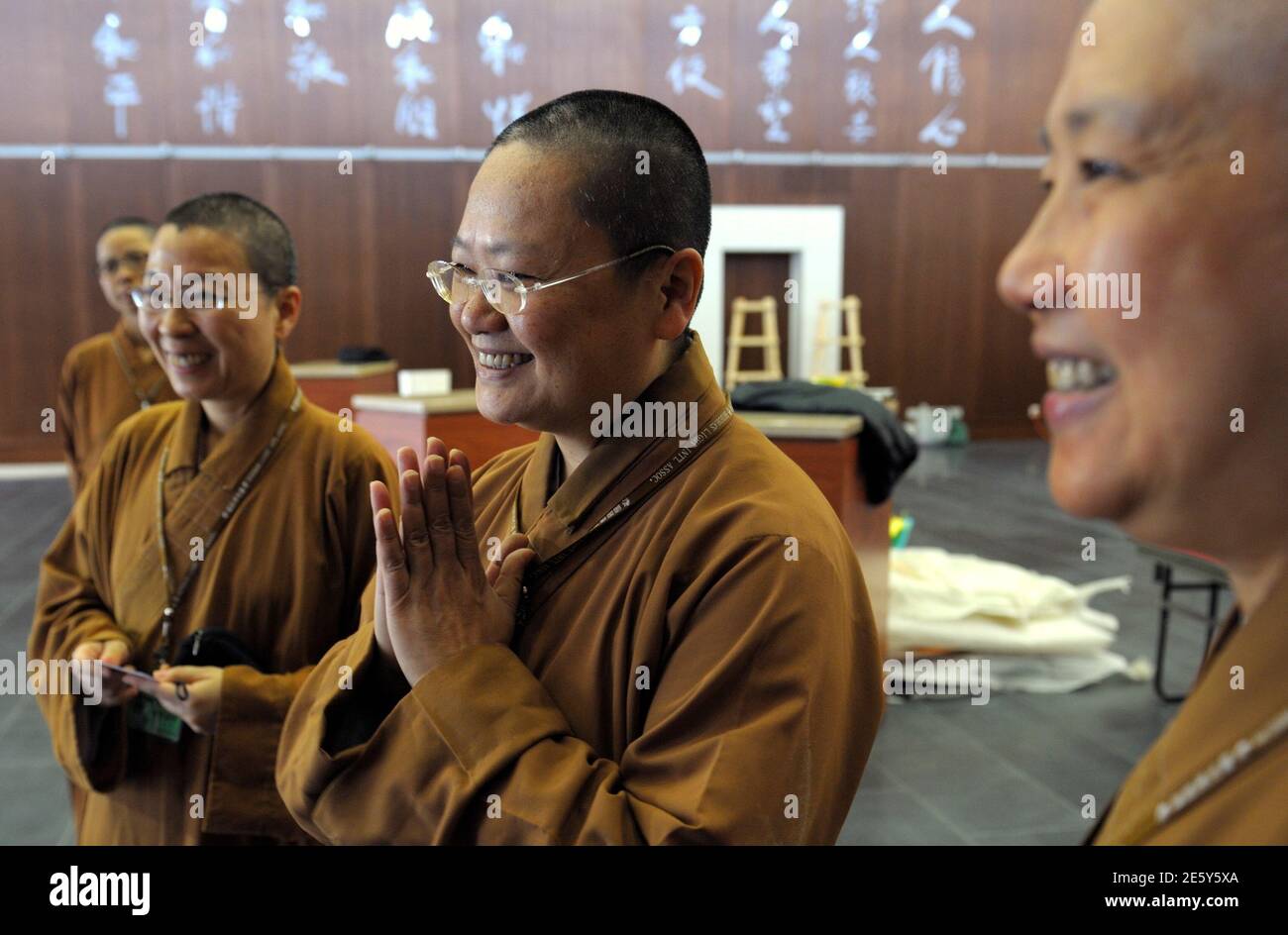 Venerable  Manchien Shih (C), who is in charge of the European Regional Temple, reacts with monks at the temple in Bussy-Saint Georges, 30 km (19 miles) east of Paris June 21, 2012. The European Regional Temple, Europe's biggest Buddhist temple and the future European headquarters of the Taiwanese monastic order of Fo Guang Shan, resides in a neighbourhood, nicknamed ?the esplanade of religions? by the city?s mayor Hugues Rondeau, which is aimed at facilitating dialogue between different communities in the city. The temple, which has the capacity to host up to 1,100 devotees, will be inaugurat Stock Photo