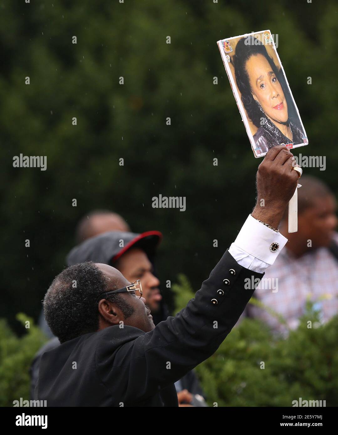 A preacher displays a picture of Coretta Scott King, the widow of Martin  Luther King Jr., during ceremonies celebrating the 50th anniversary of the  1963 "March on Washington" at the Lincoln Memorial