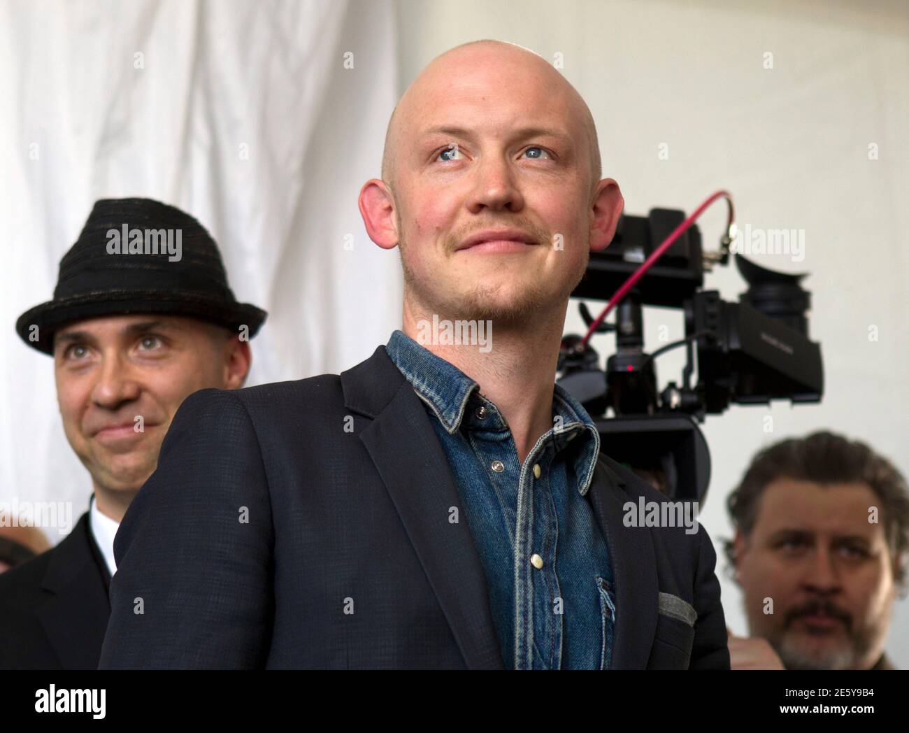 Isaac Slade (C), lead singer of The Fray, attends the grand opening of the Ivanpah Solar Electric Generating System in the Mojave Desert near the California-Nevada border February 13, 2014. The project, a partnership of NRG, BrightSource, Google and Bechtel, is the world's largest solar thermal facility. The Fray made a music video at the facility.  REUTERS/Steve Marcus (UNITED STATES - Tags: ENERGY ENTERTAINMENT BUSINESS SCIENCE TECHNOLOGY) Stock Photo